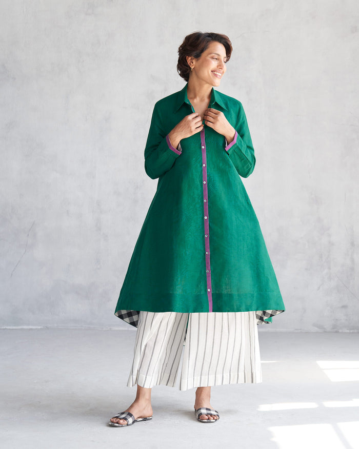 Person wearing a green Midori High Low Kurta with a purple button placket.