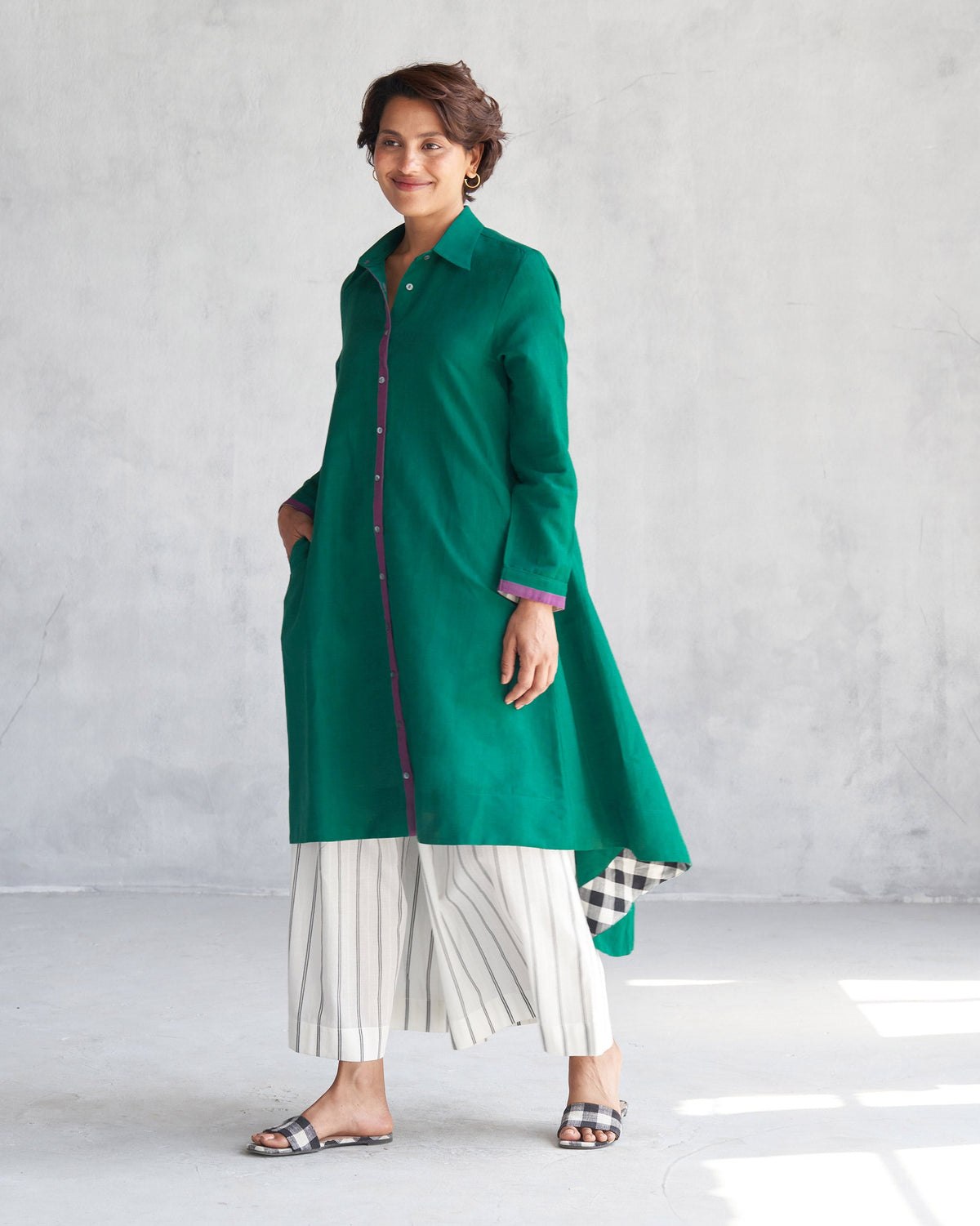 Person wearing a green Midori High Low Kurta showing the longer back hem.