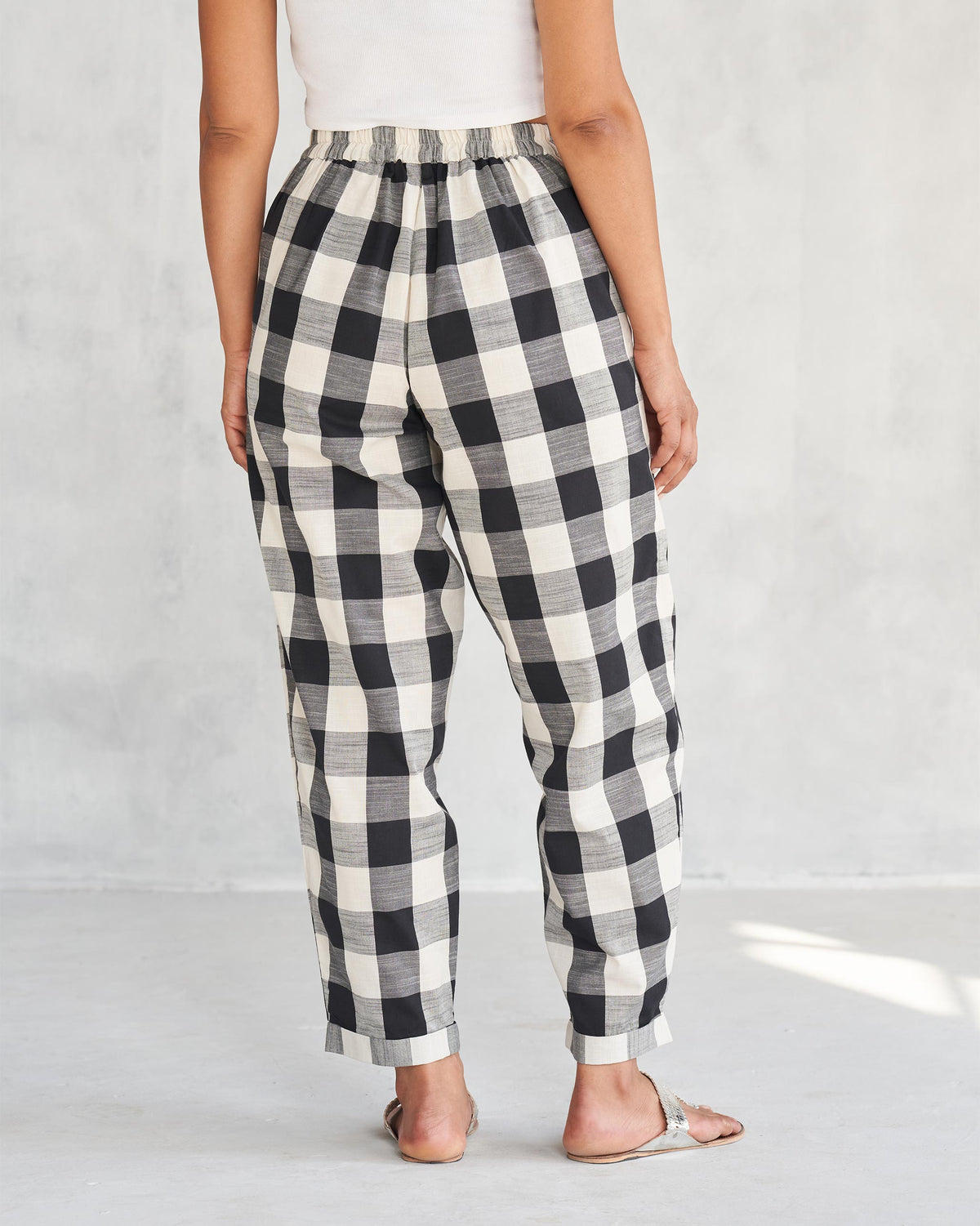 Back of black and ivory Midori Pants worn by a person.