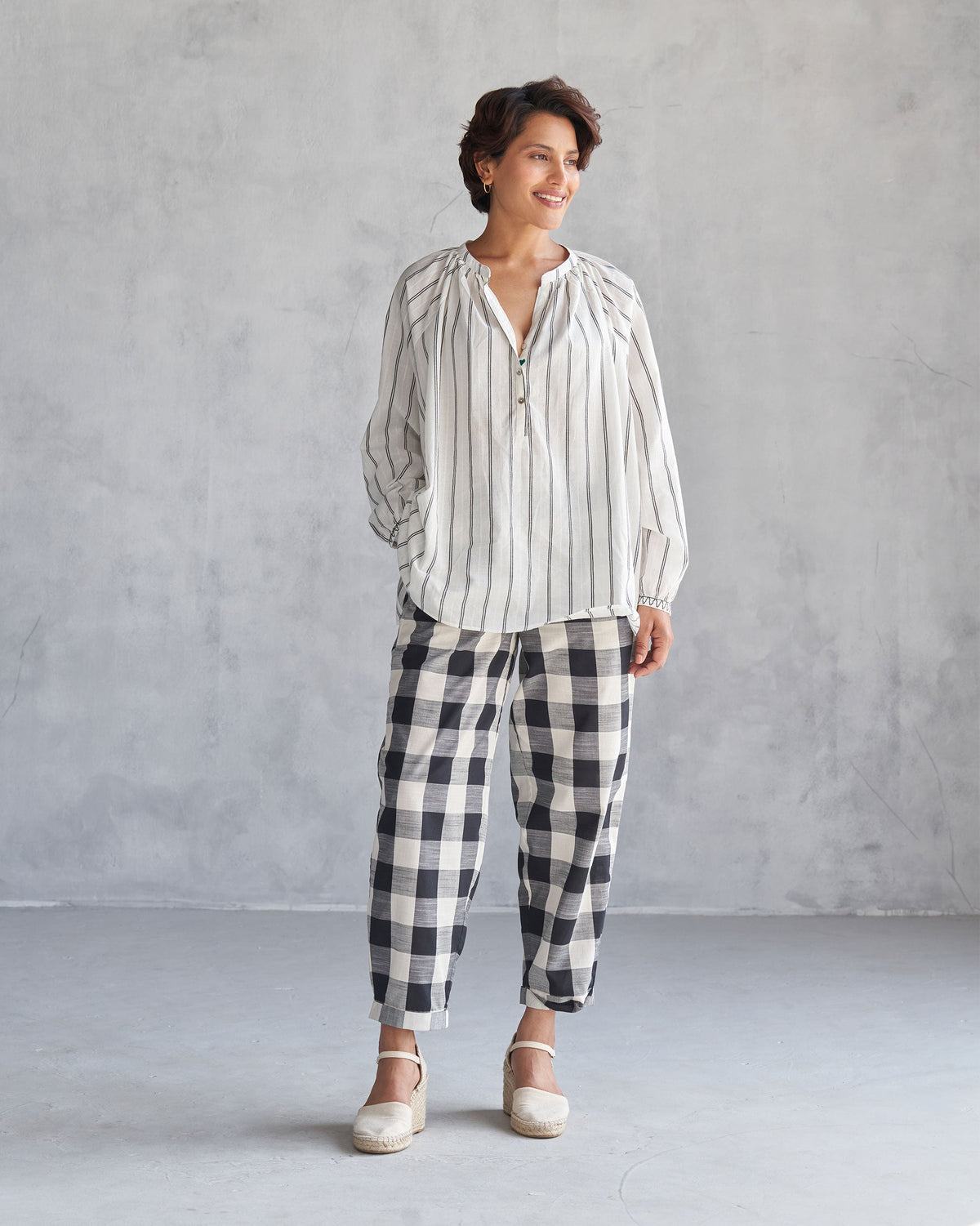 Person wearing black and ivory Midori Pants.