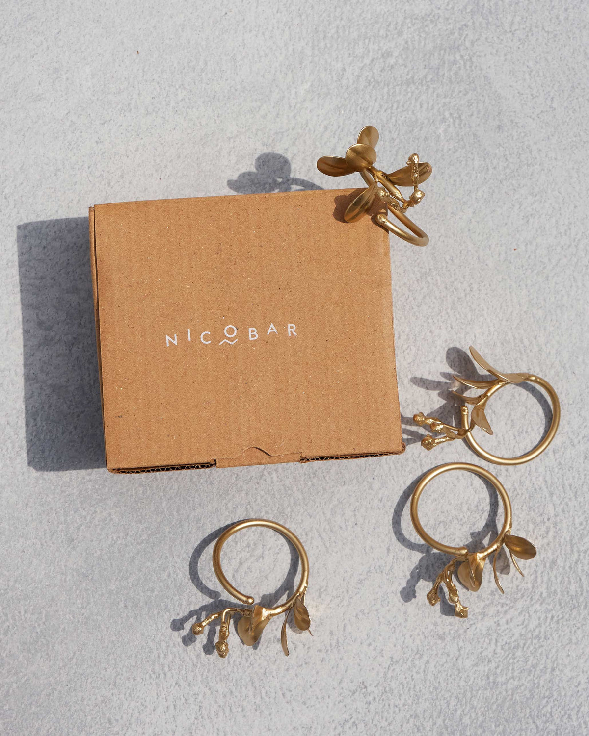 Clove Napkin Ring in use on a folded napkin.