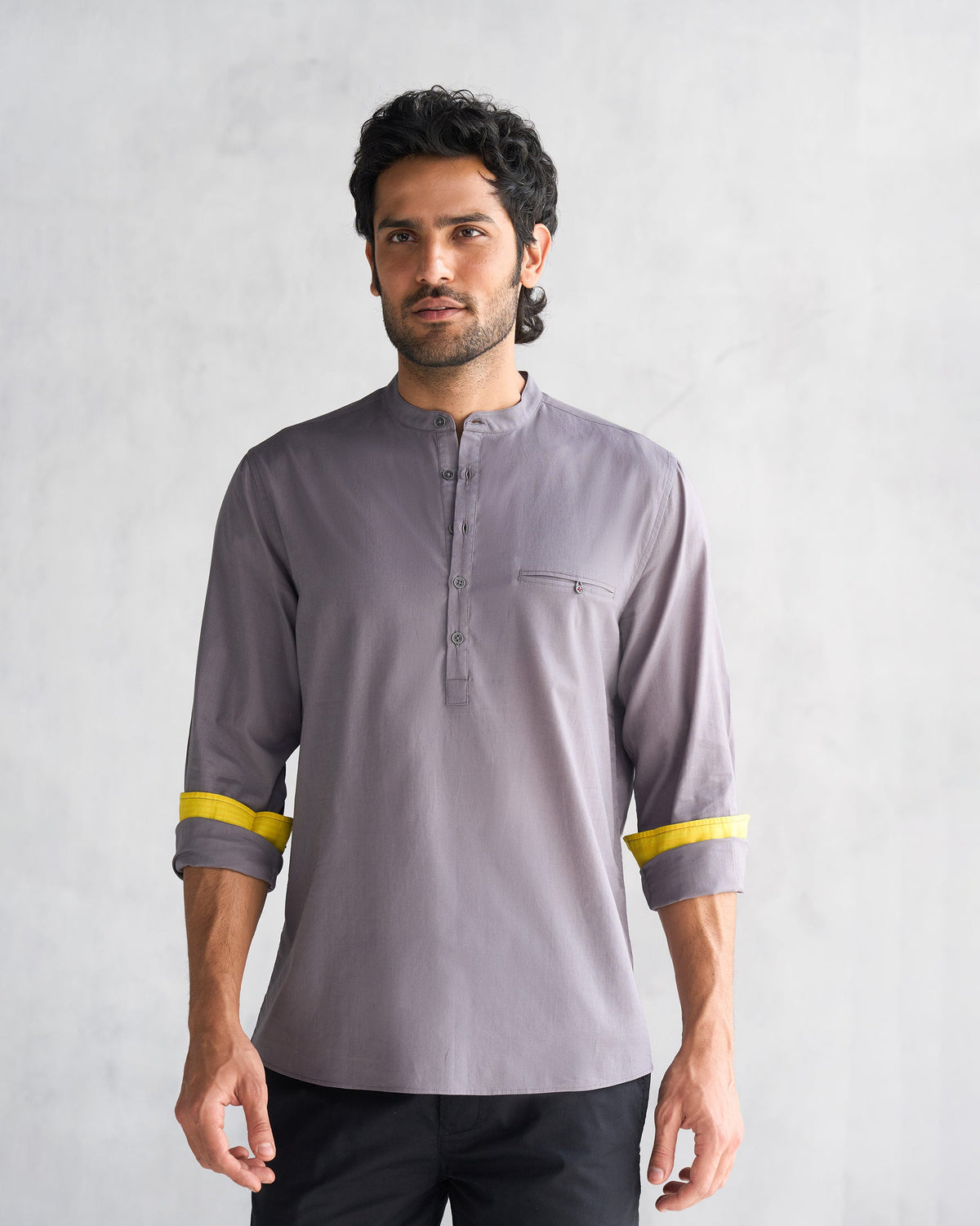 Person wearing the Pondicherry Shirt in charcoal with yellow cuff lining.