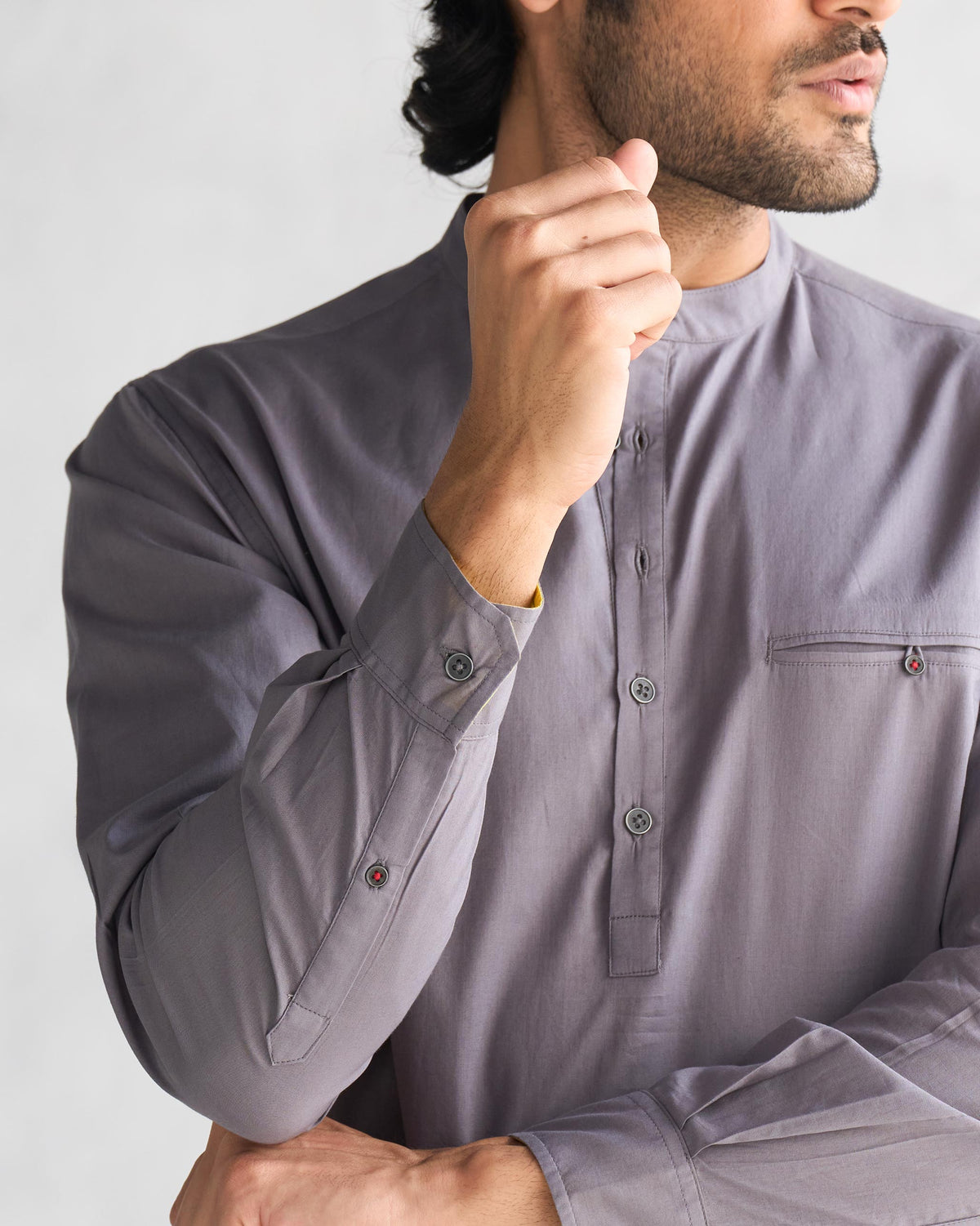 Close-up of the Pondicherry Shirt's placket and pocket, with a small red button.