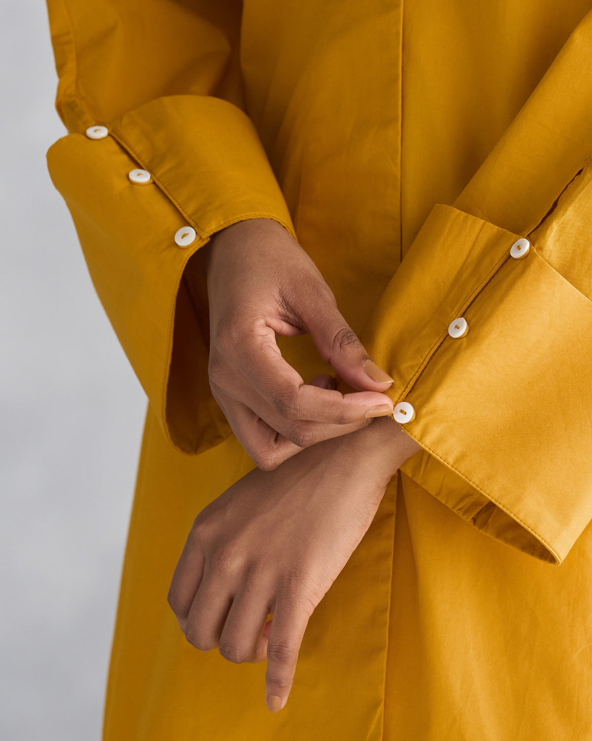 Close-up of Cirrus Shirt showing white button cuffs on the sleeves.
