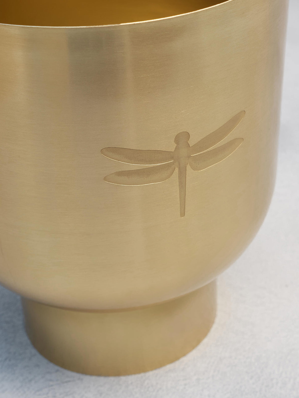 Close-up of a Luna Planter showing an engraved dragonfly motif.