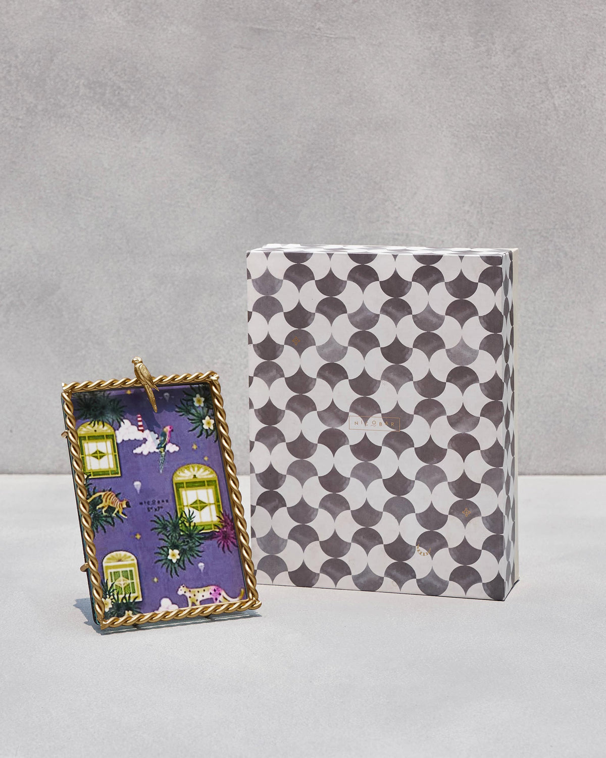 Zanzibar Photo frame standing beside its grey and white patterned box.