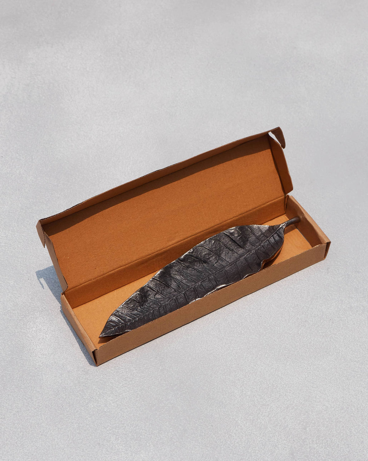 Mango leaf Incense Holder placed inside its open box.