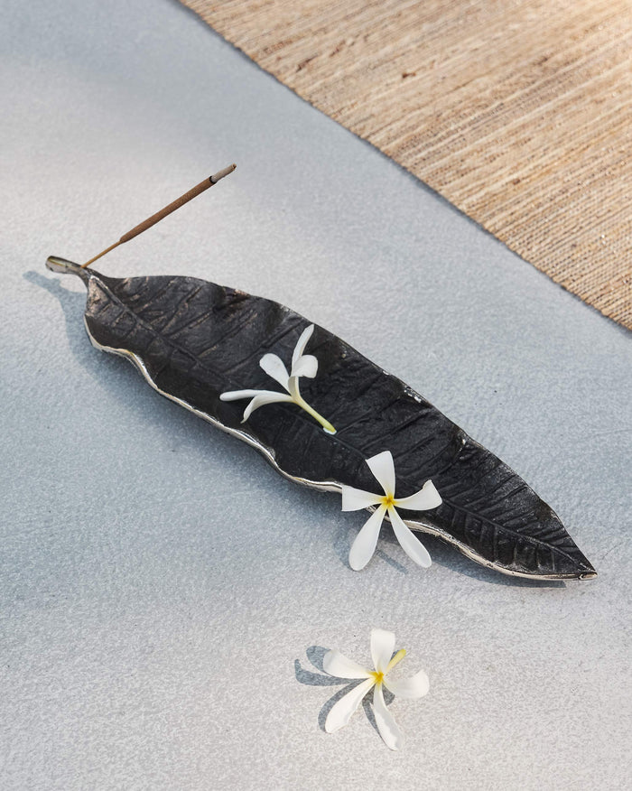 Mango leaf Incense Holder with an incense stick resting across it.