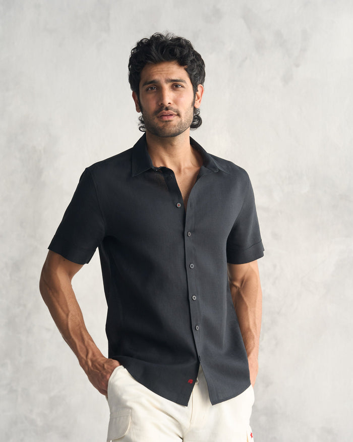 Person wearing a black half sleeve shirt.