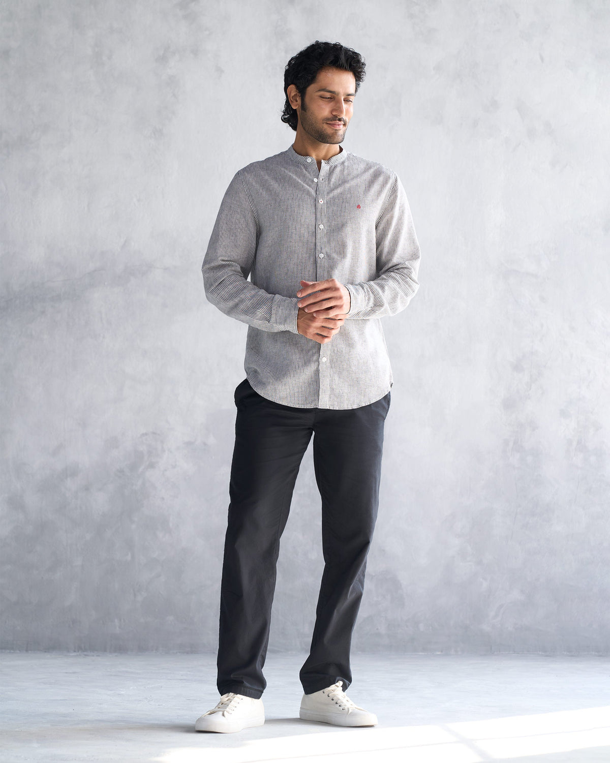 Full-length front of a charcoal stripe Nawab shirt worn by a person.