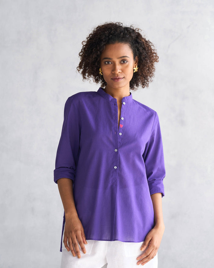 Person wearing a purple Mandarin Collar Top with rolled sleeves and shell buttons.