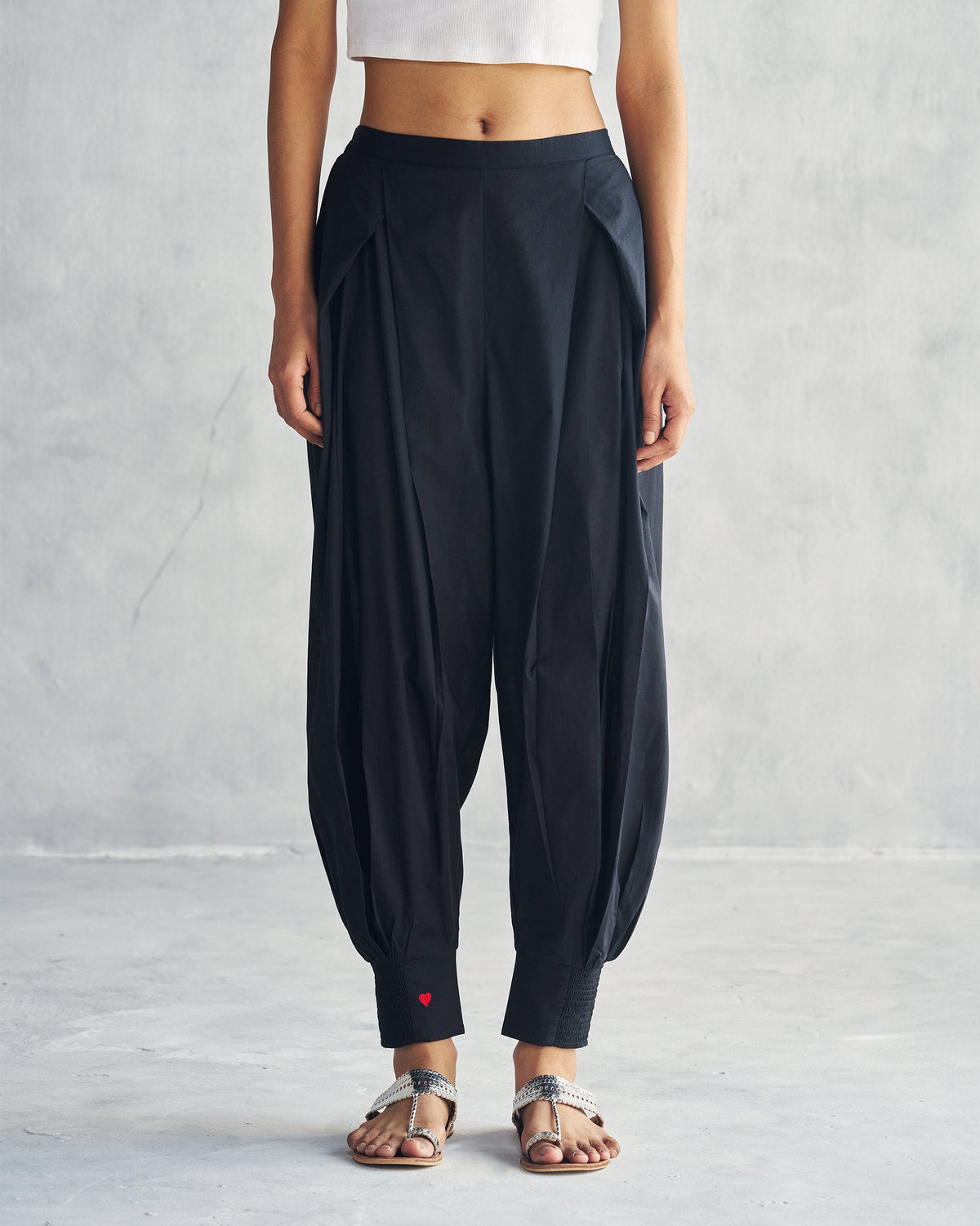 Person wearing black Puff Pants with cuffed ankles.