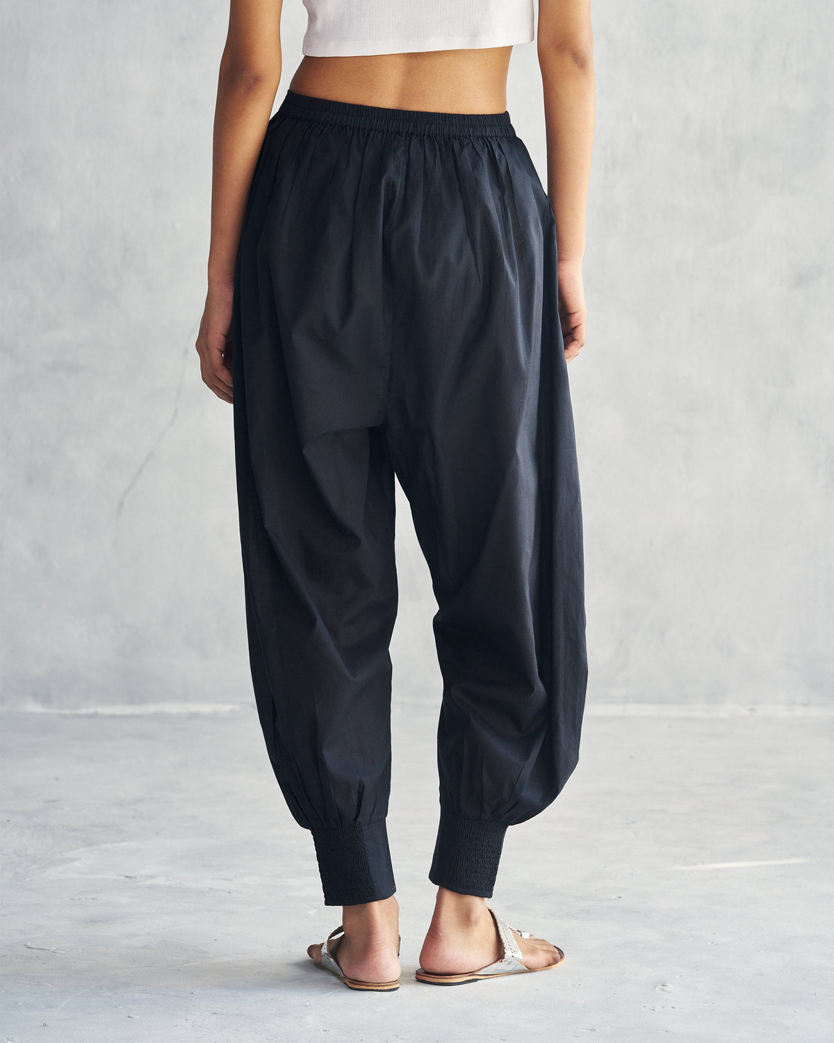 Back of black Puff Pants with smocked cuffs.