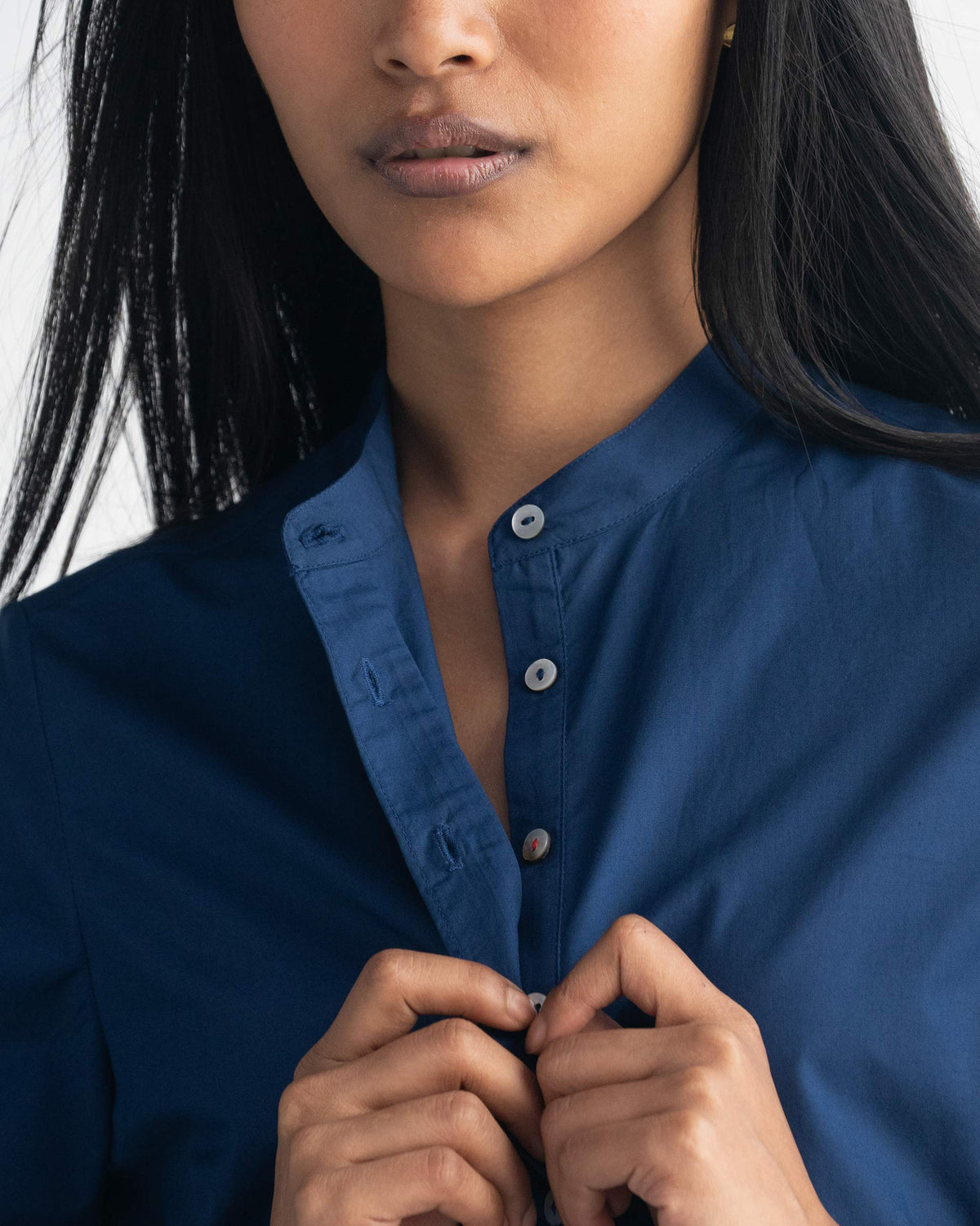 Close-up of the Pema Top placket and band collar with pale buttons.