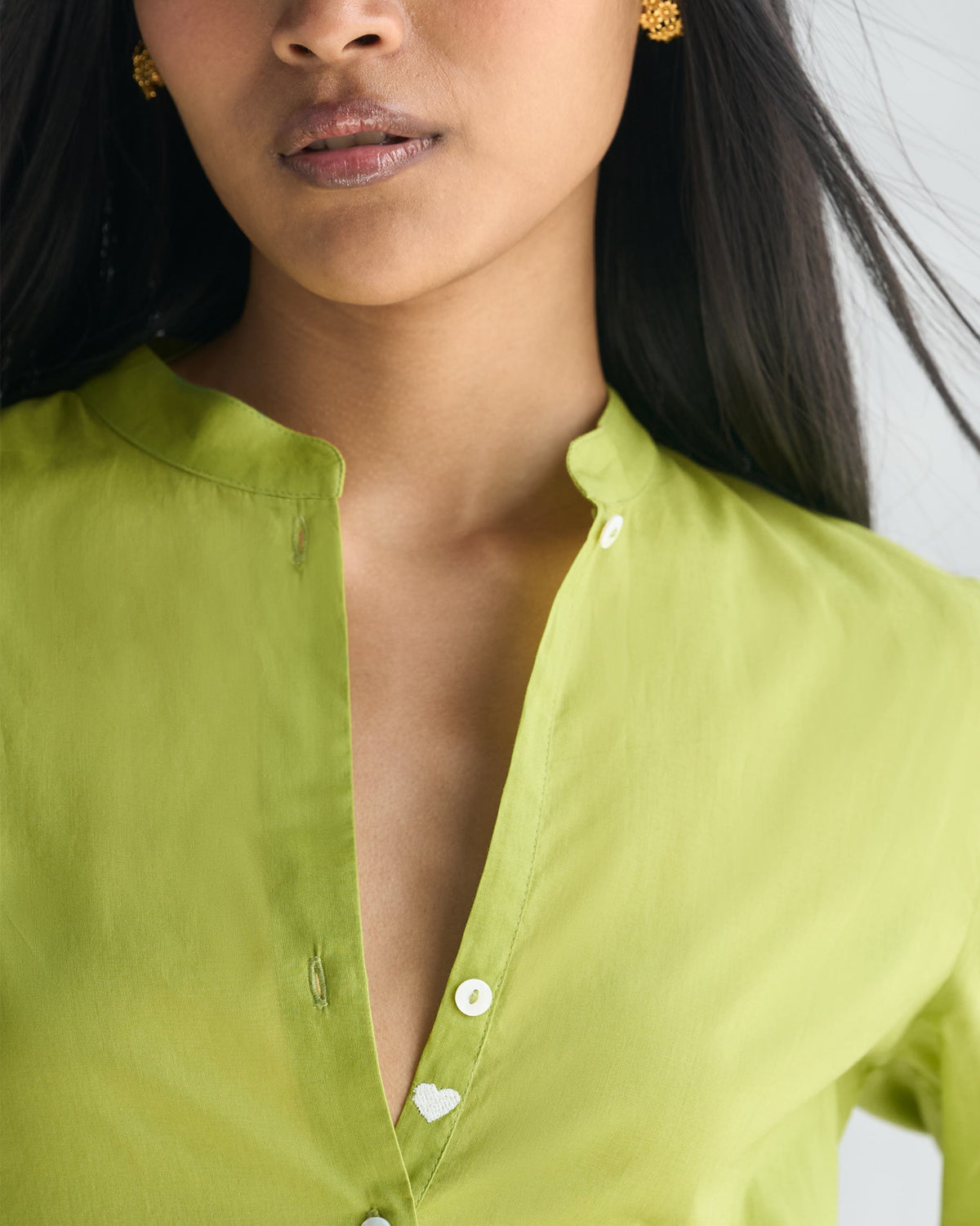 Close-up of the Basic long length kurta's band collar and placket with a small white heart button.