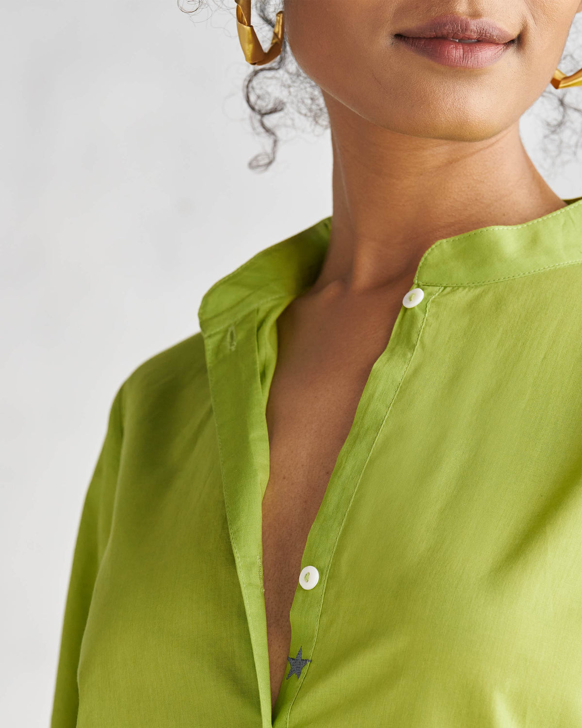 Close-up of a lime Basic Mid Length Kurta placket showing a small blue star.