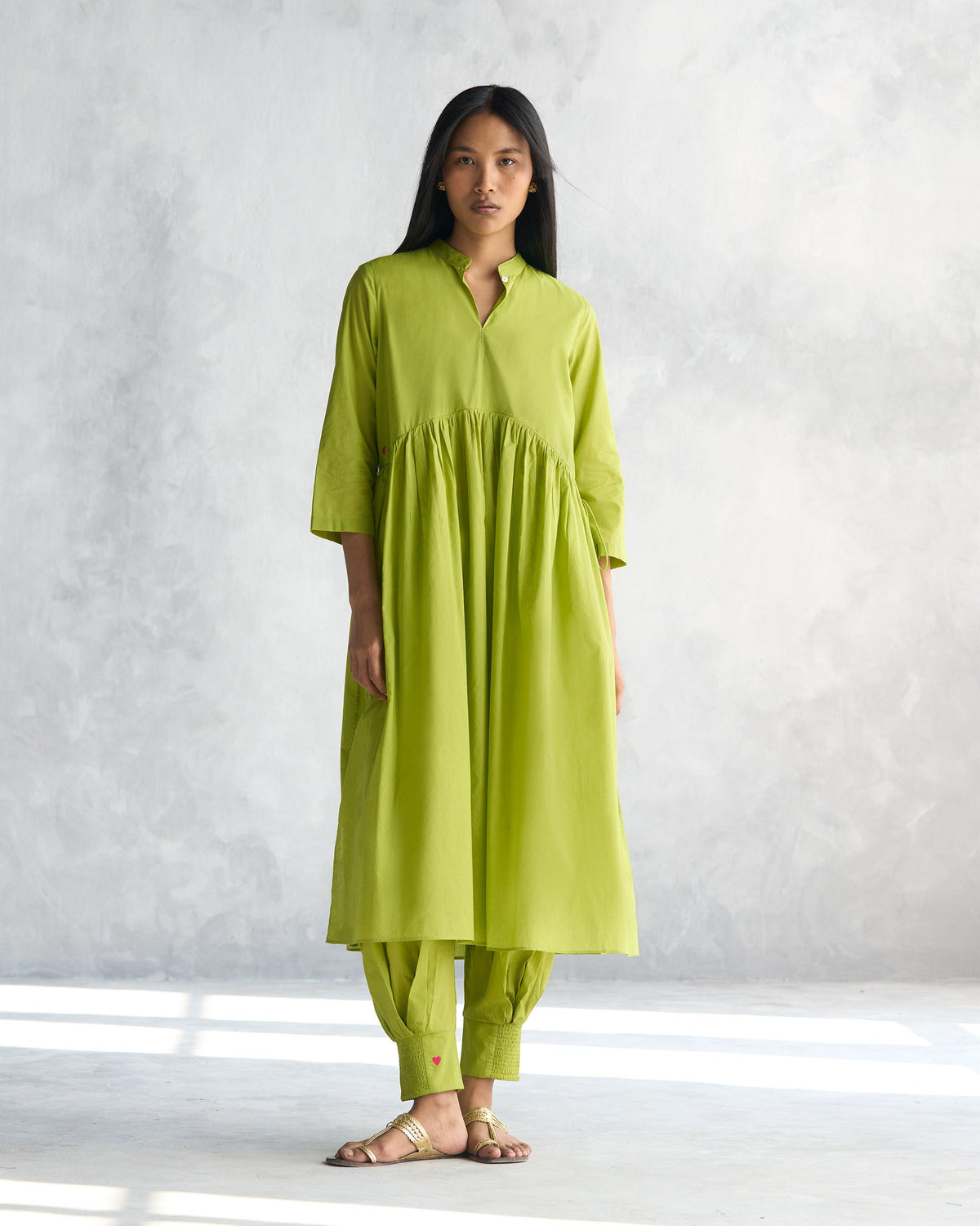 Person wearing a lime waist gathered kurta with gathers below the yoke.