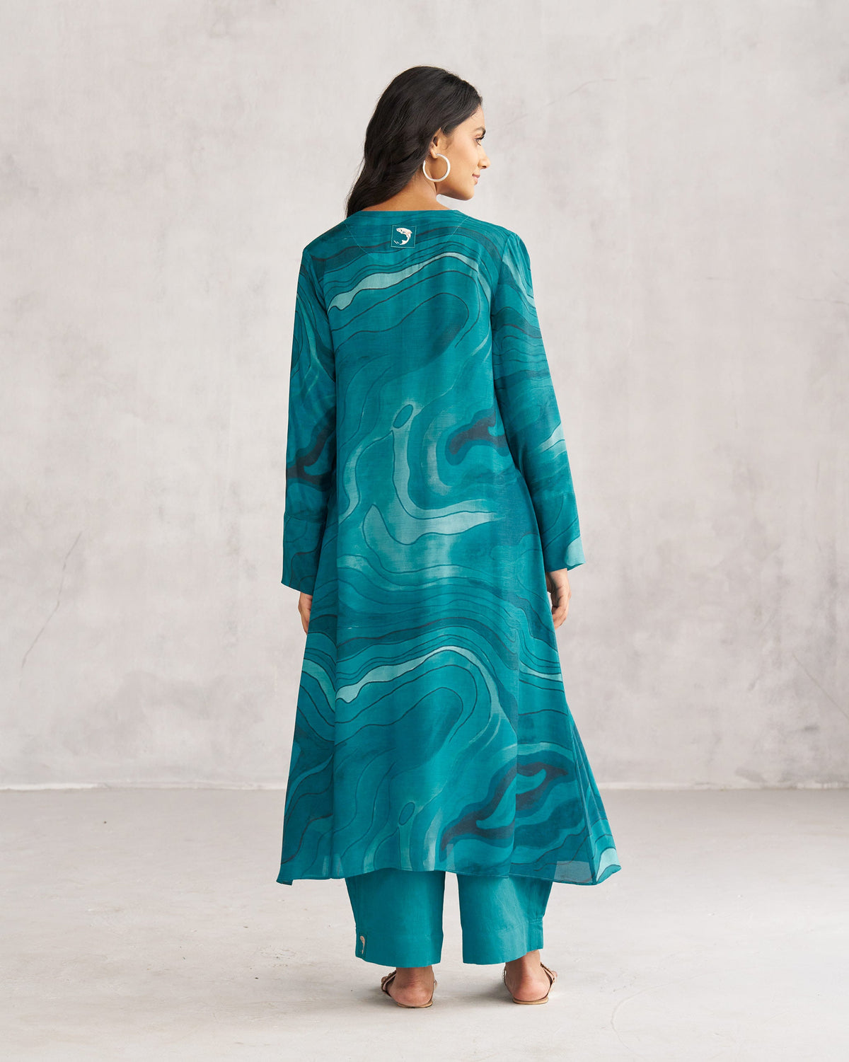Back of a teal V-Neck Flare Kurta worn by a person.