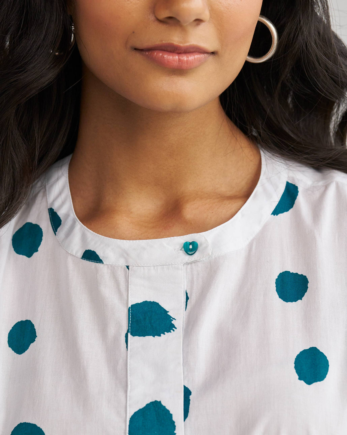 Close-up of the Boba panelled kurta neckline with a teal button.