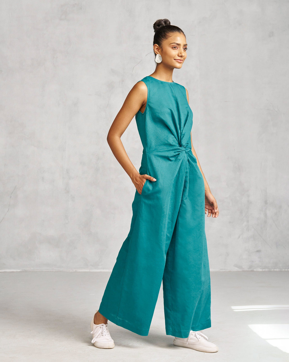 Side view of the Front Knot Jumpsuit in teal showing the knot at the waist.