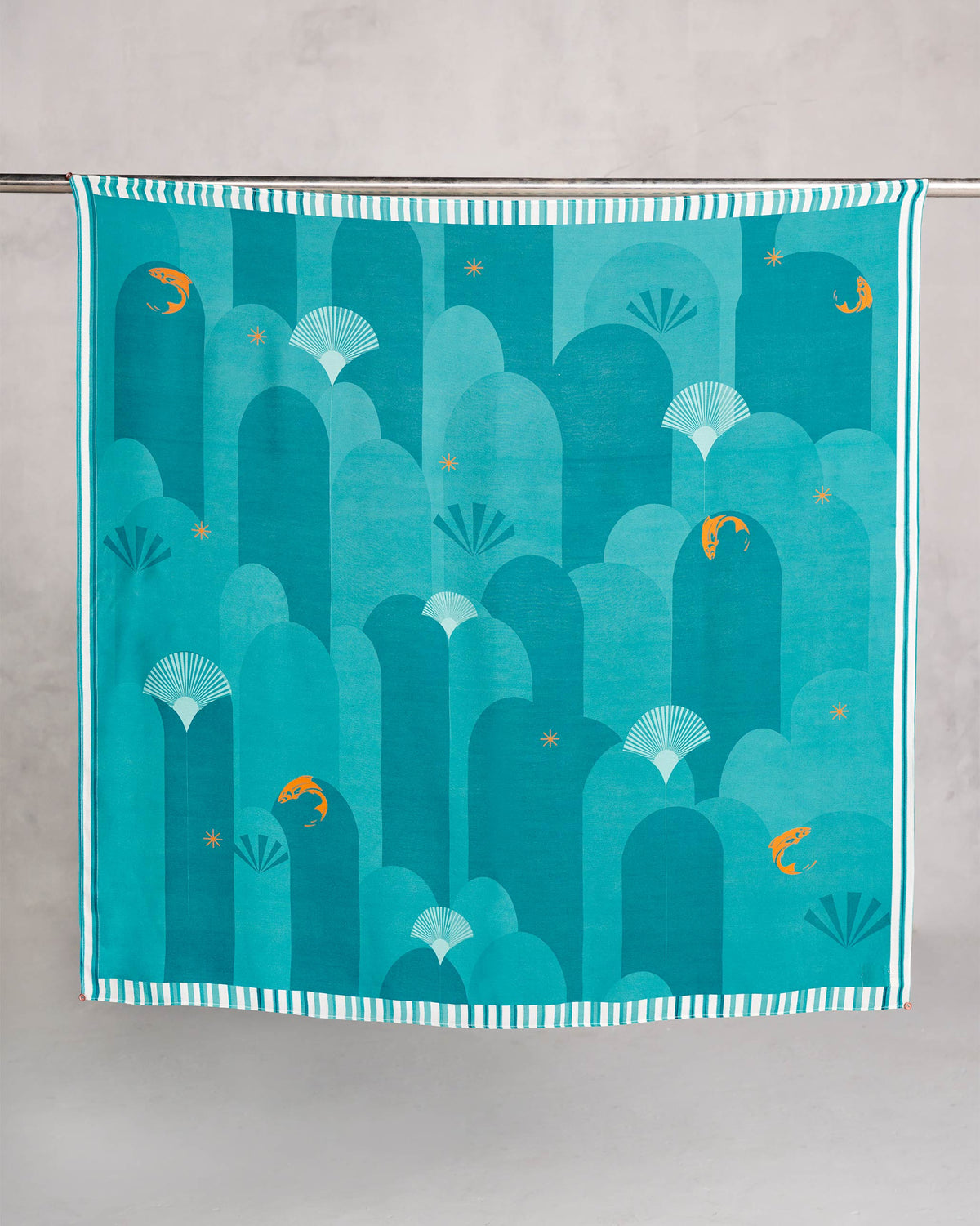 Pacific Scarf hung flat, showing teal arches, fan shells and orange fish.