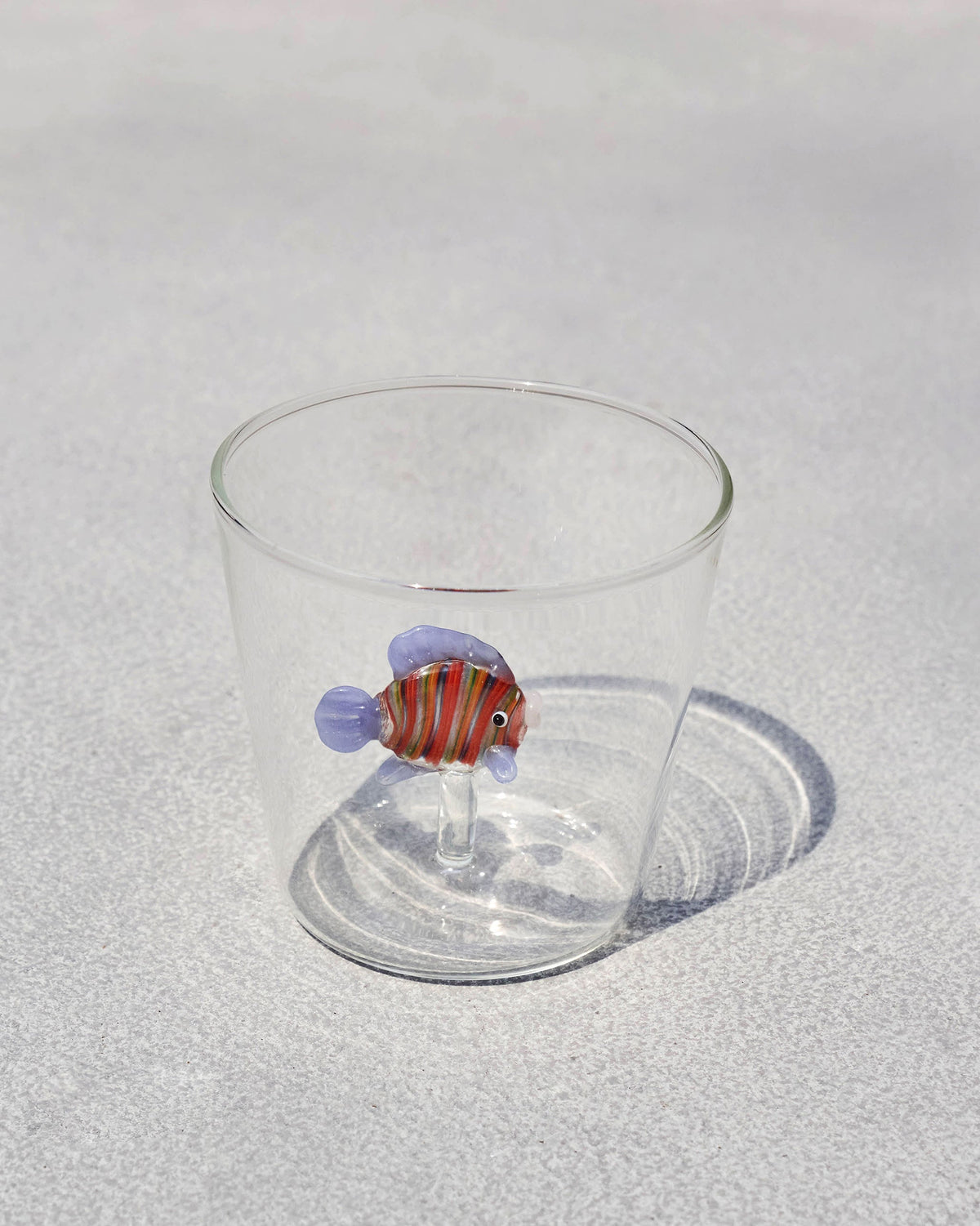 Angelfish Glass with a striped glass fish on its side.