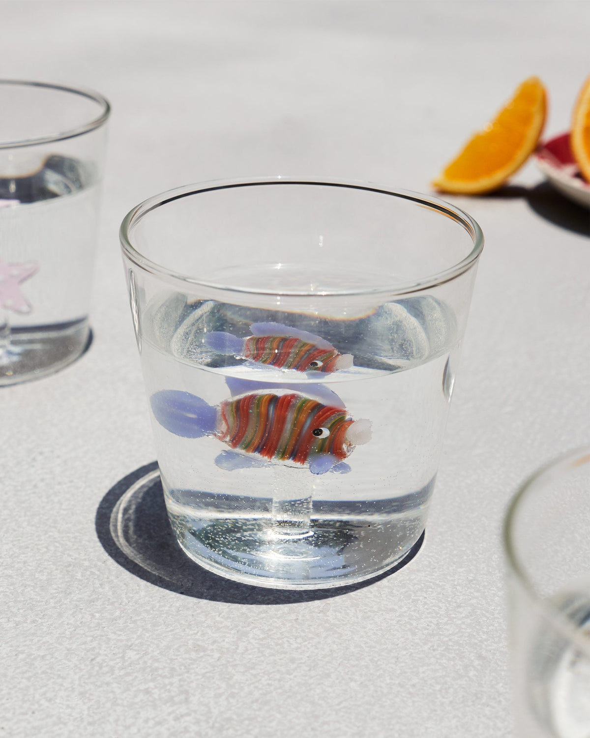 Angelfish Glass filled with water, showing its fish through the liquid.