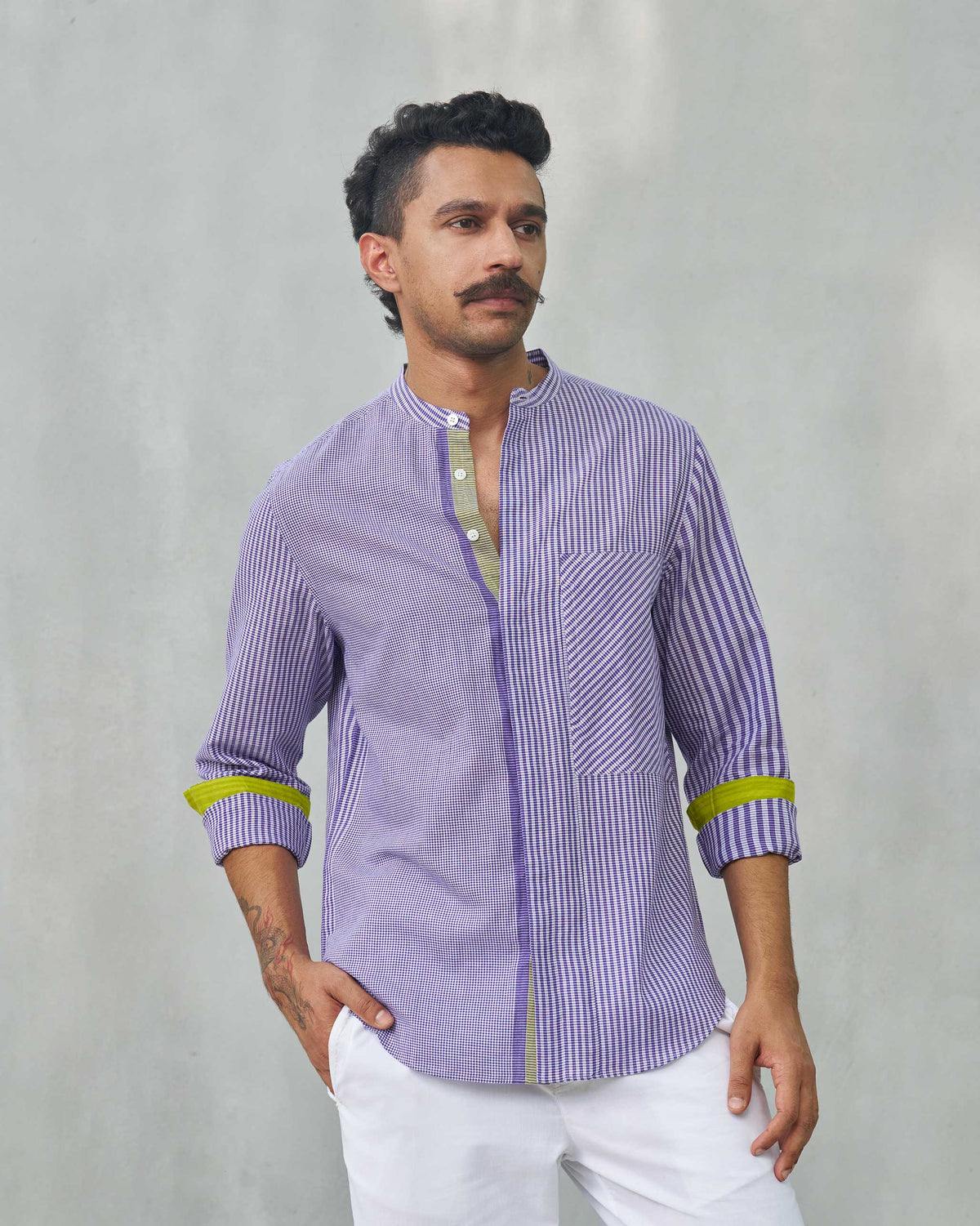 Person wearing a purple Summer Fridays Pocket Shirt with a chest pocket.