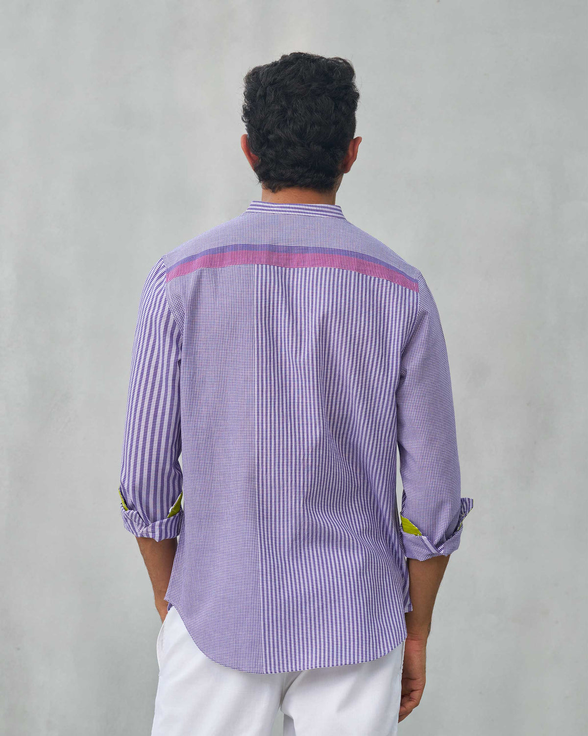 Back of a purple Summer Fridays Pocket Shirt worn by a person.