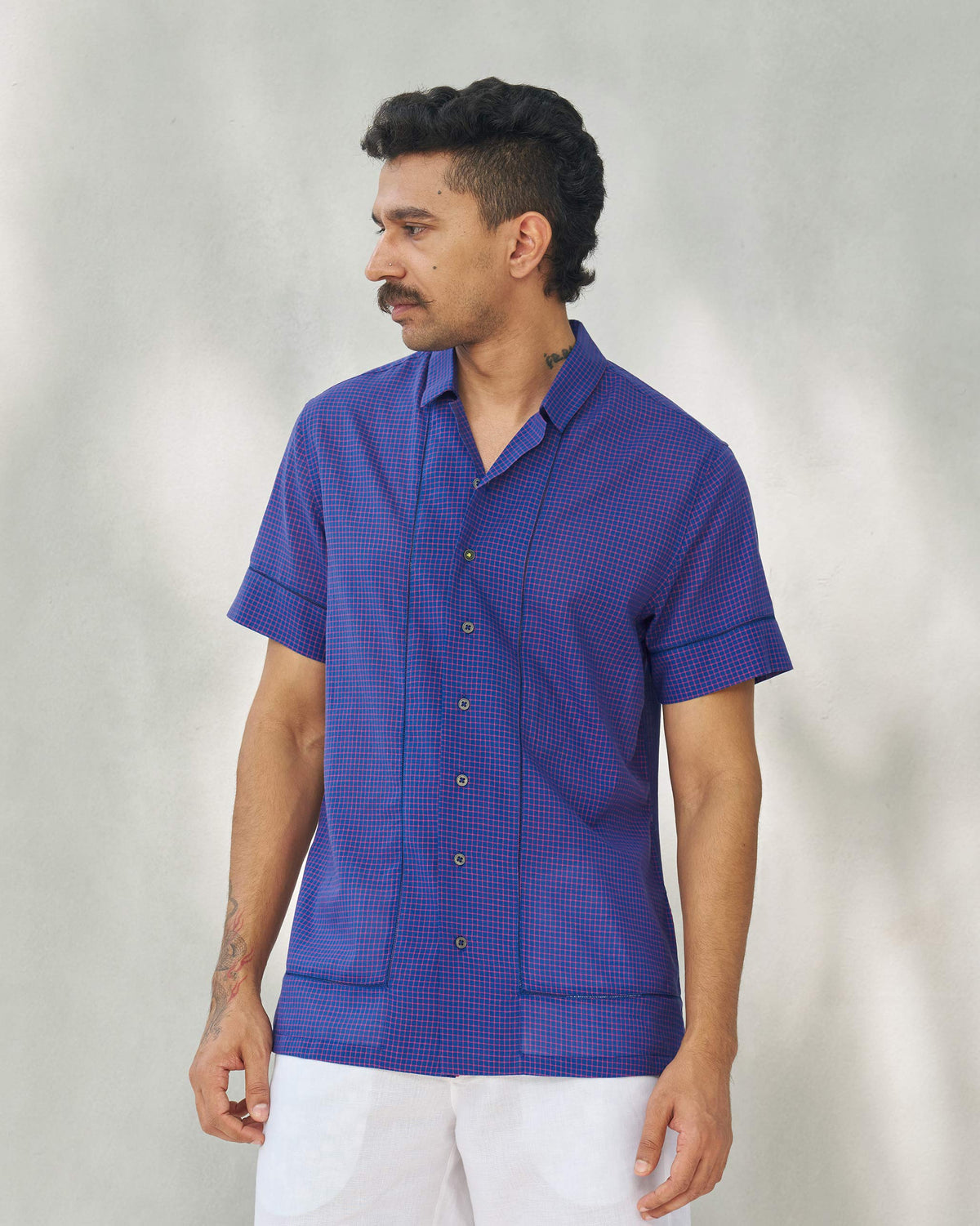 Person wearing a Coastal Shirt with a button placket and patch pockets down the front.