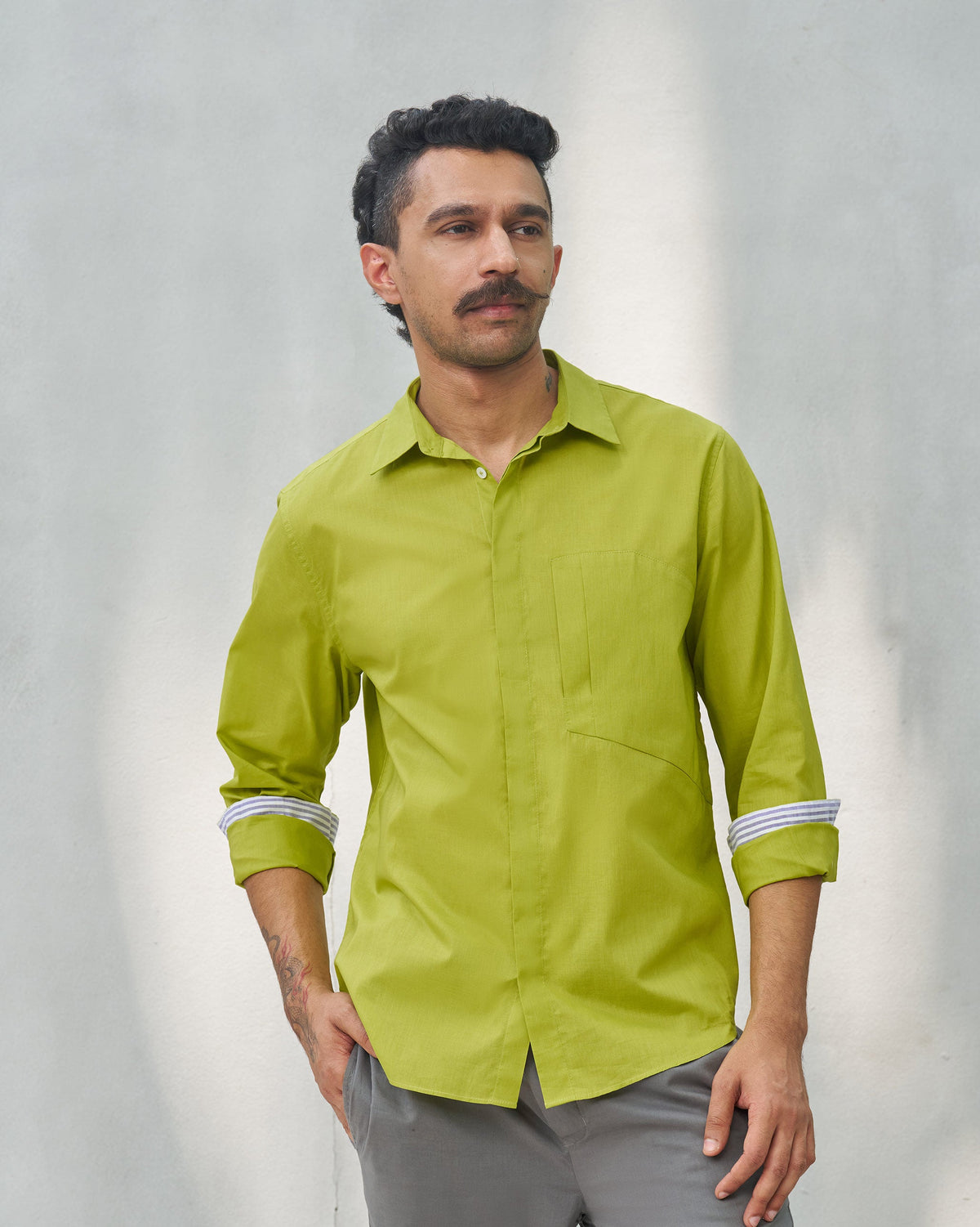 Person wearing the Padma Shirt in lime with a point collar and chest pocket.