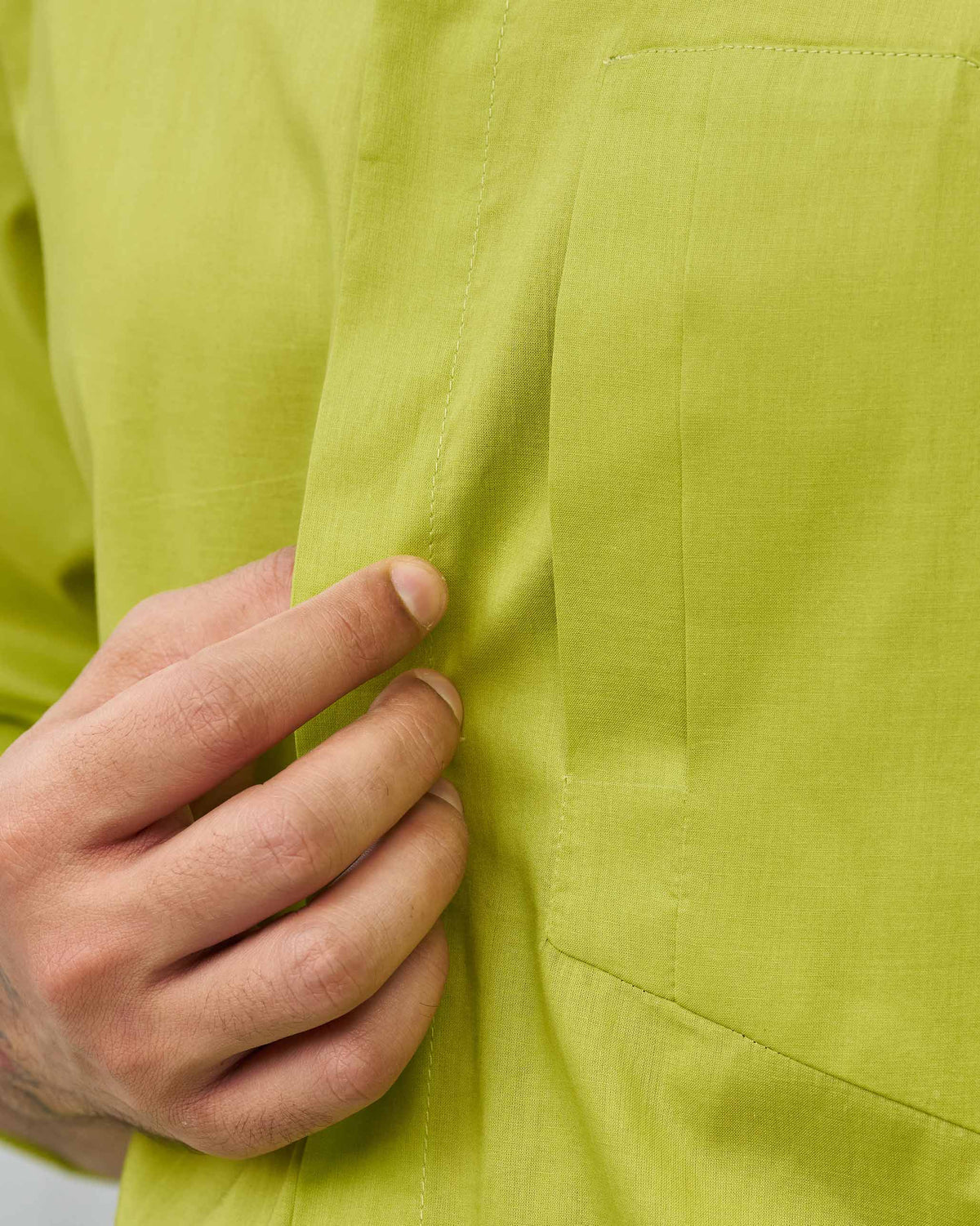 Close-up of the Padma Shirt's chest pocket and front placket in lime.