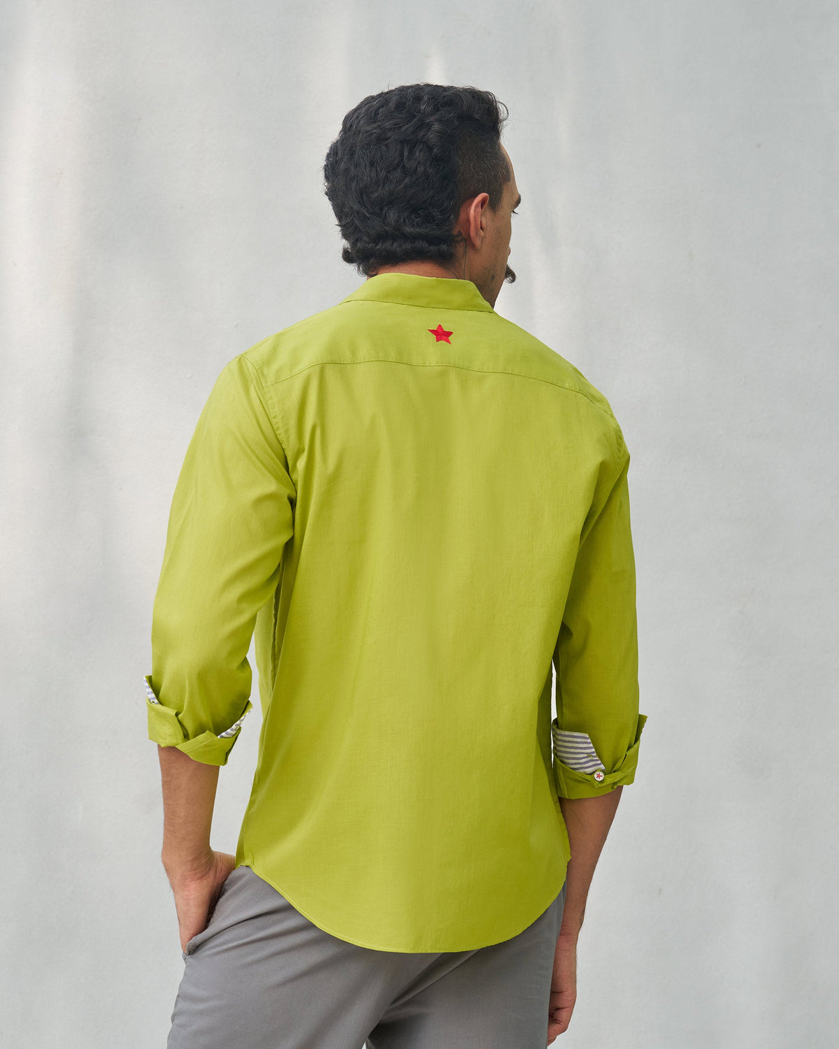 Back of the Padma Shirt worn by a person, with a red star on the yoke.