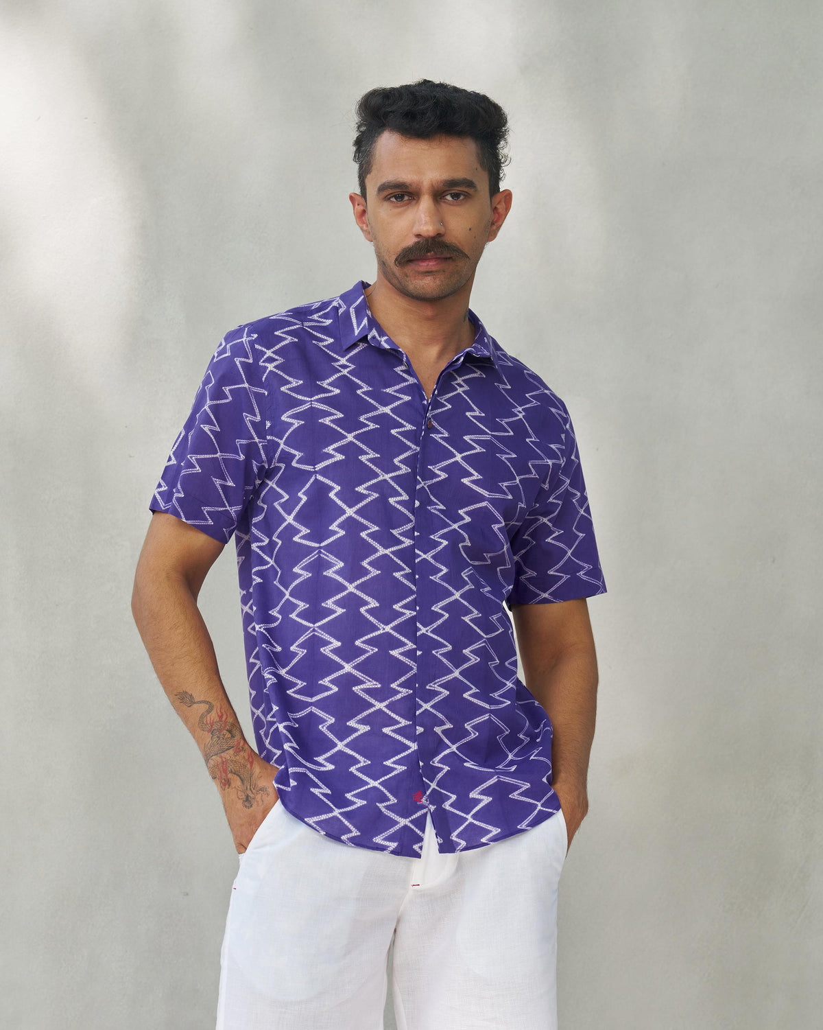Person wearing a purple Riverine shirt with a white zigzag print.