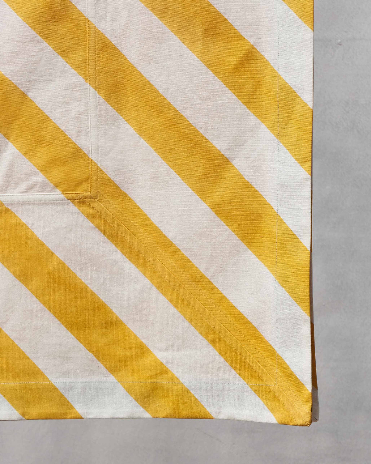 Close-up of a Zanzibar Table Cloth Small corner showing its stitched hem.