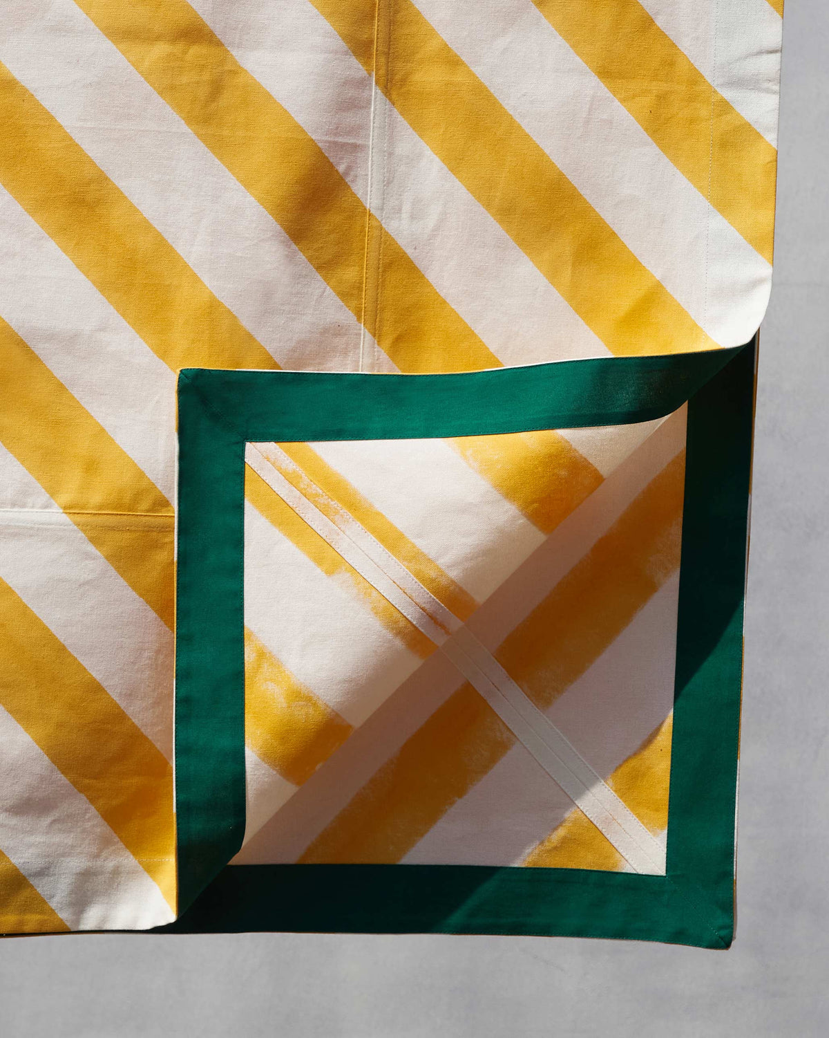 Corner of a Zanzibar Table Cloth Small folded back to show its green border.