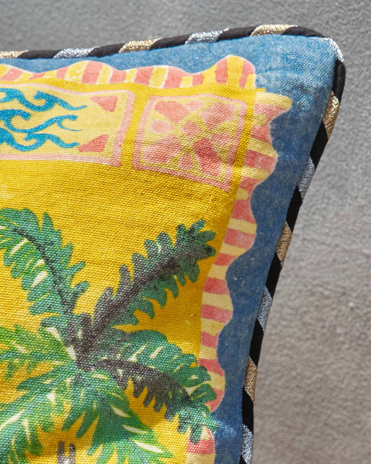 Close-up of a Pineapple Stamp Cushion Cover corner showing palm fronds and a blue border.