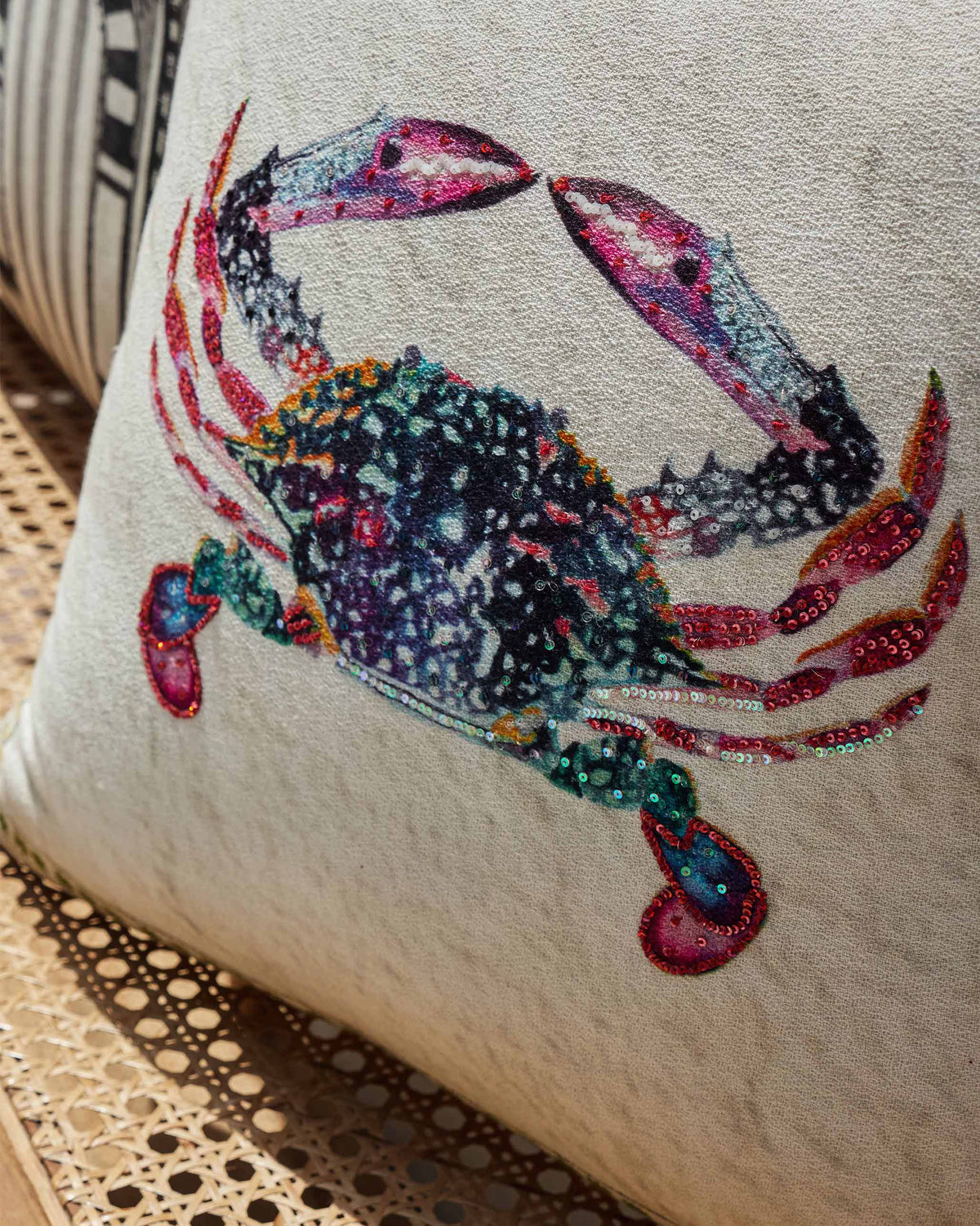 Close-up of the Crab Cushion Cover showing the embroidered crab with sequin detailing.