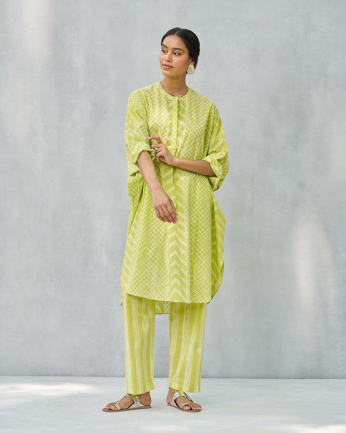 Person wearing a lime and ivory Lazy Sunday tunic with a lattice print.
