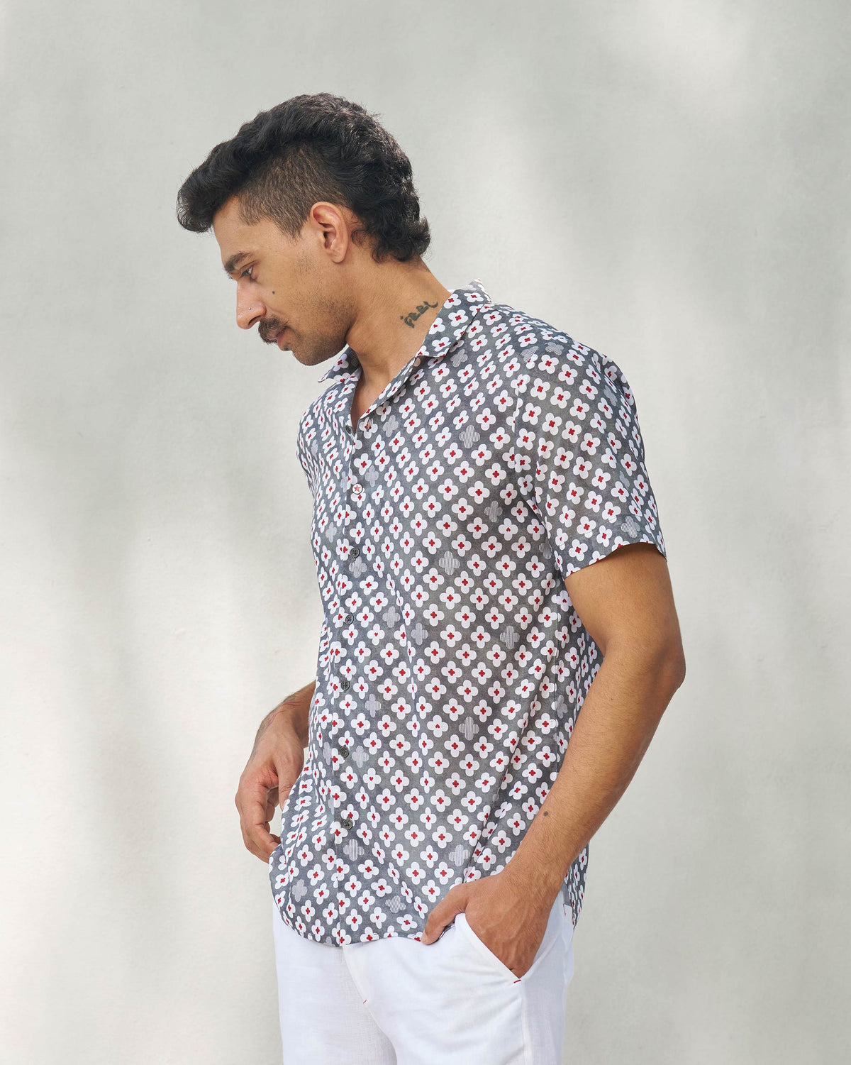 Side view of a grey Mistari shirt worn by a person.