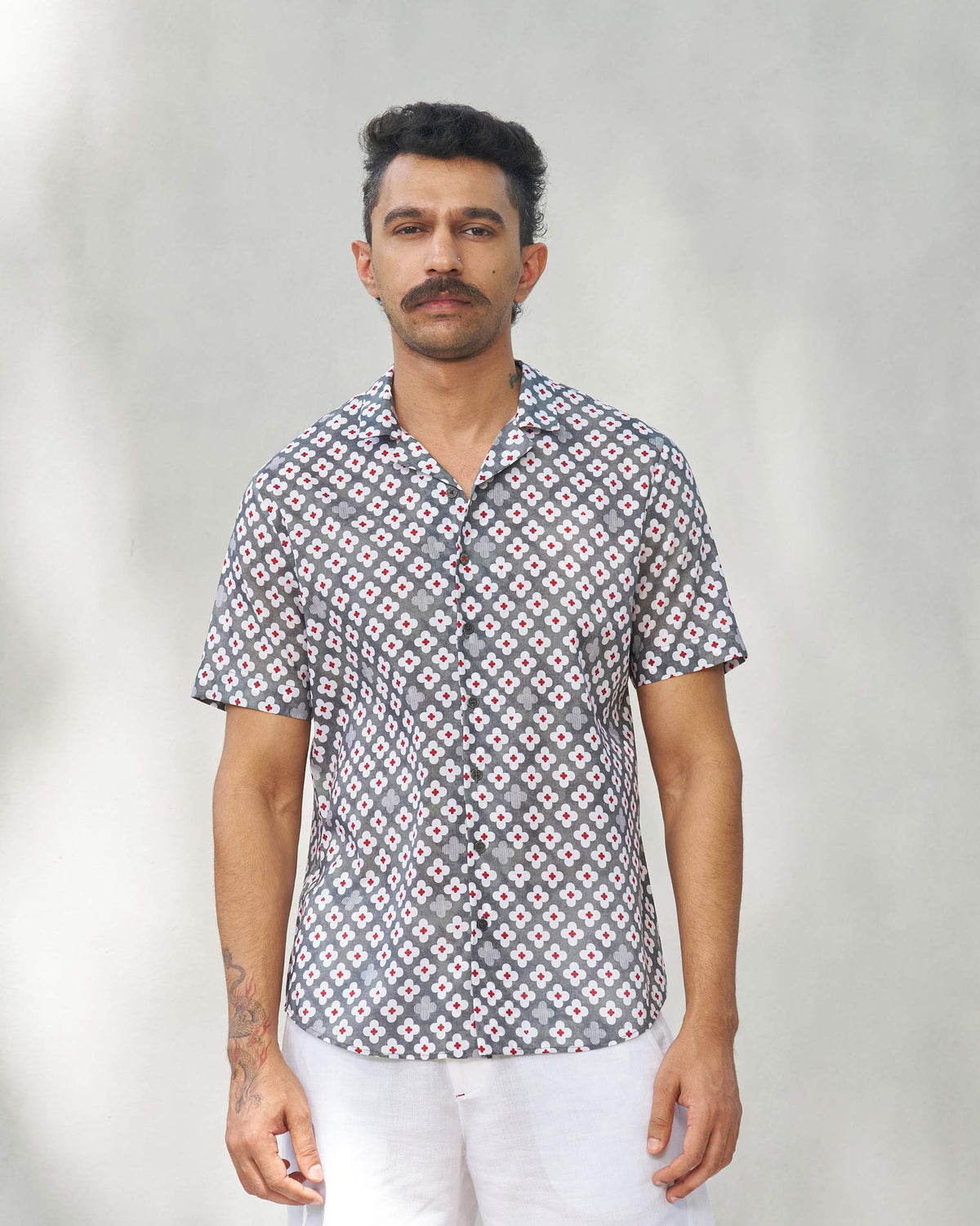 Person wearing a grey Mistari shirt with a camp collar.