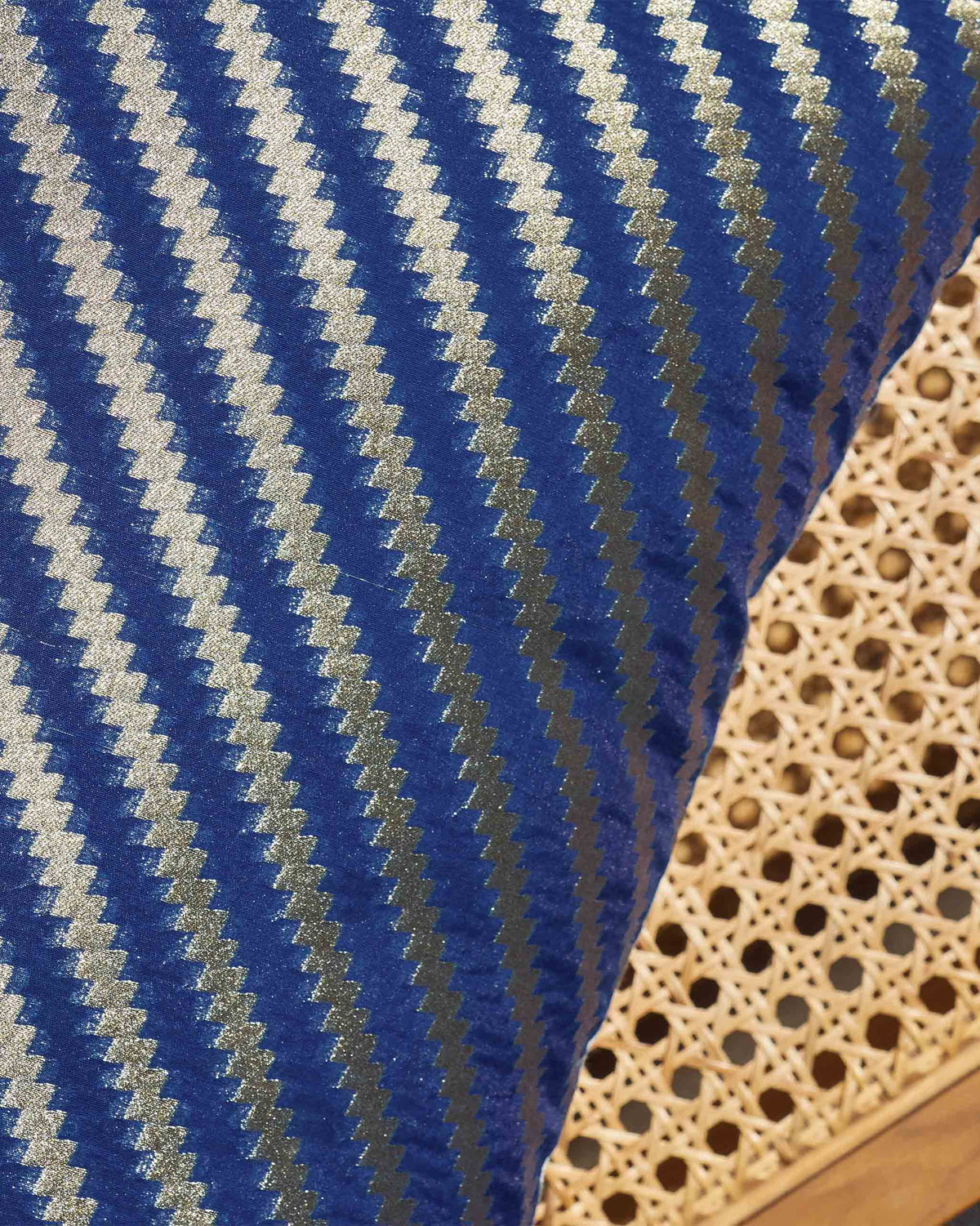 Close-up of a Whimsical Chanderi Sham showing blue fabric with gold zigzag stripes.