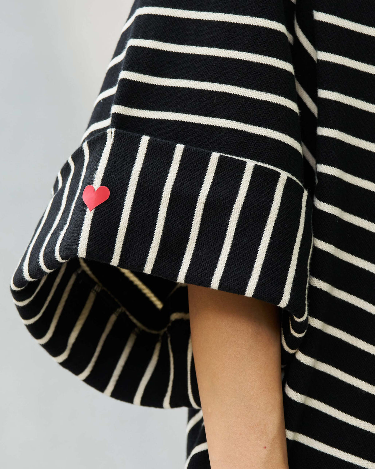Close-up of an Amelia kaftan sleeve cuff with a small red heart.