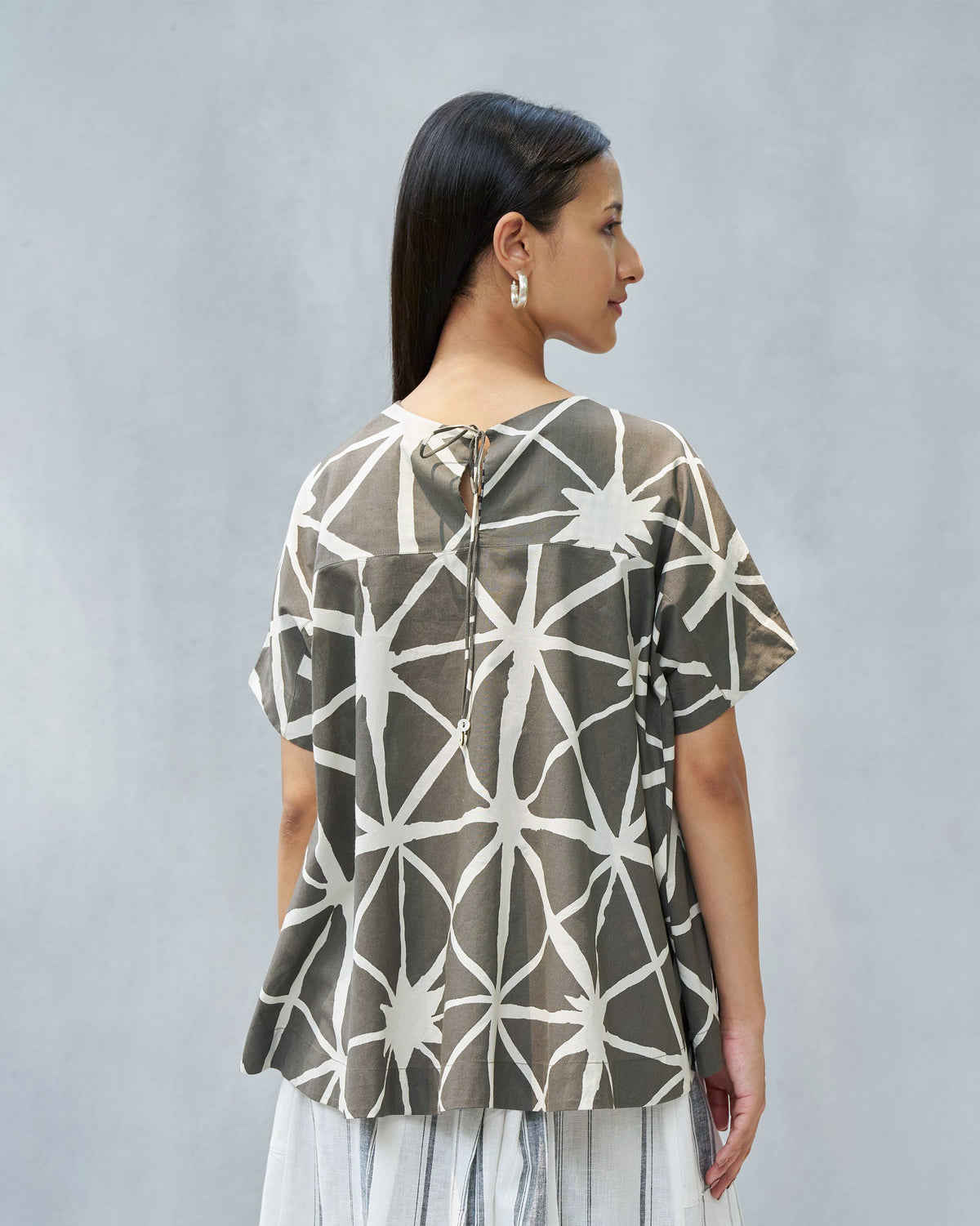 Back of a Gina top worn by a person, showing the loose drape.