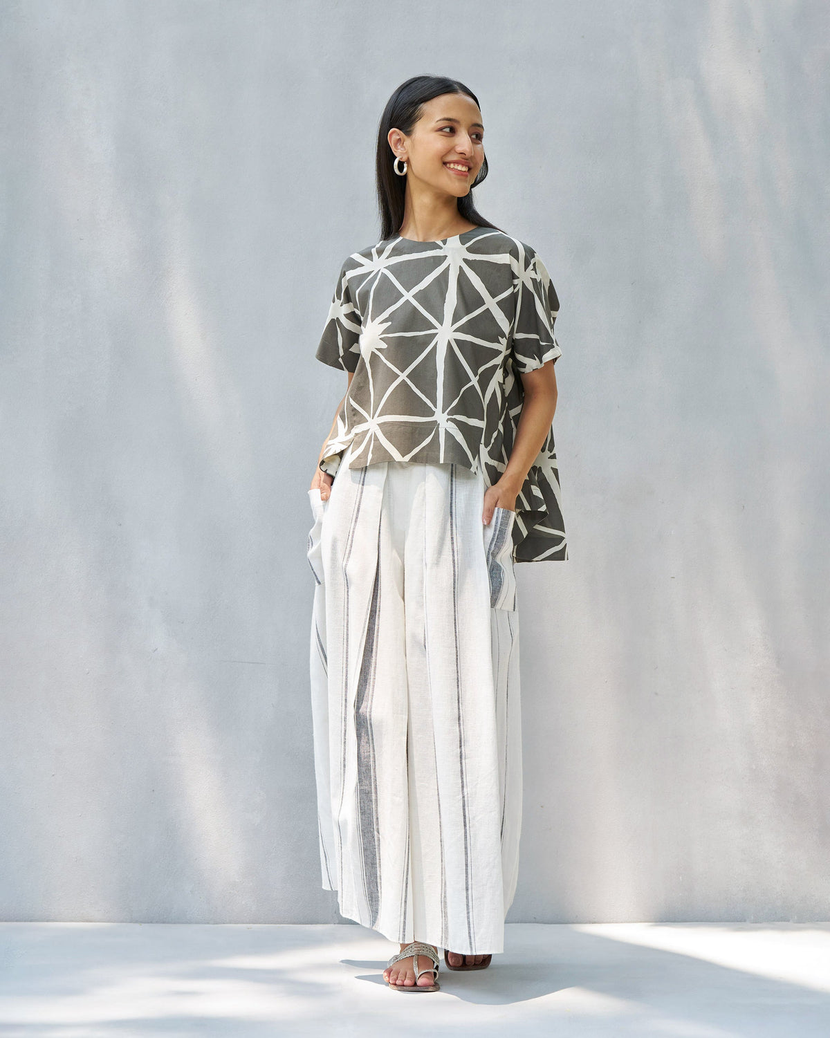 Person wearing a Gina top with a short-sleeved, boxy fit.