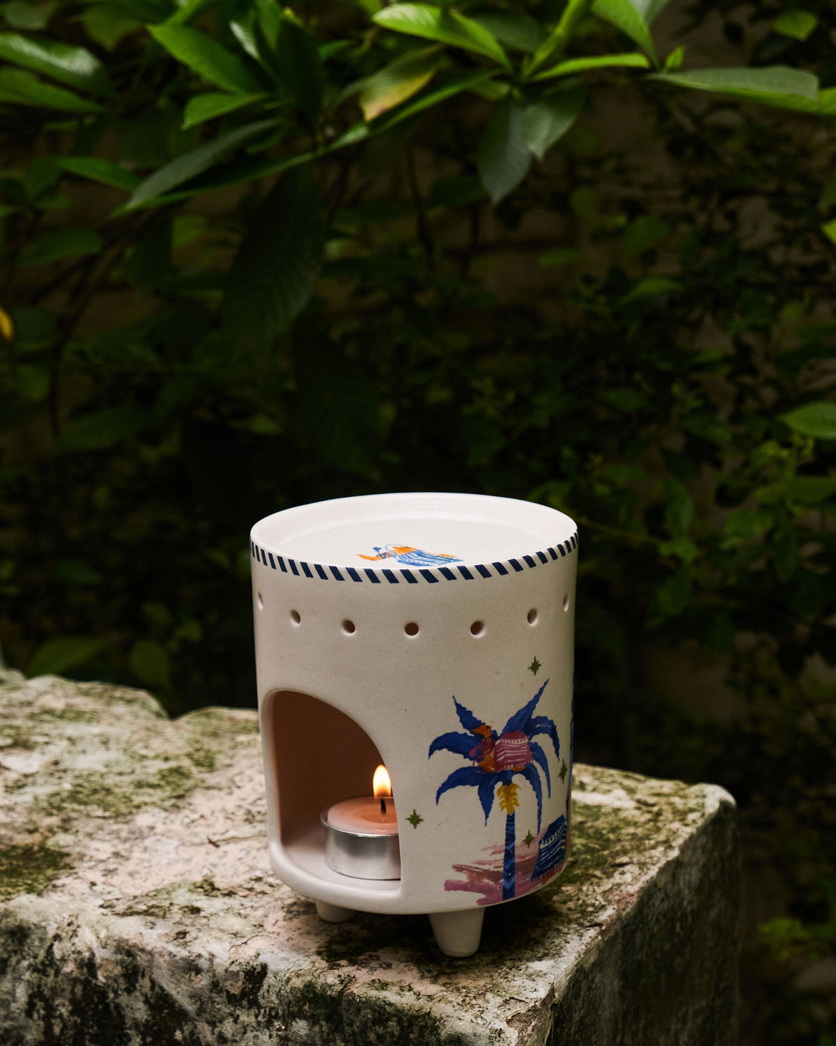 Sahara Diffuser with a tea light lit inside, showing its cut-out sides.
