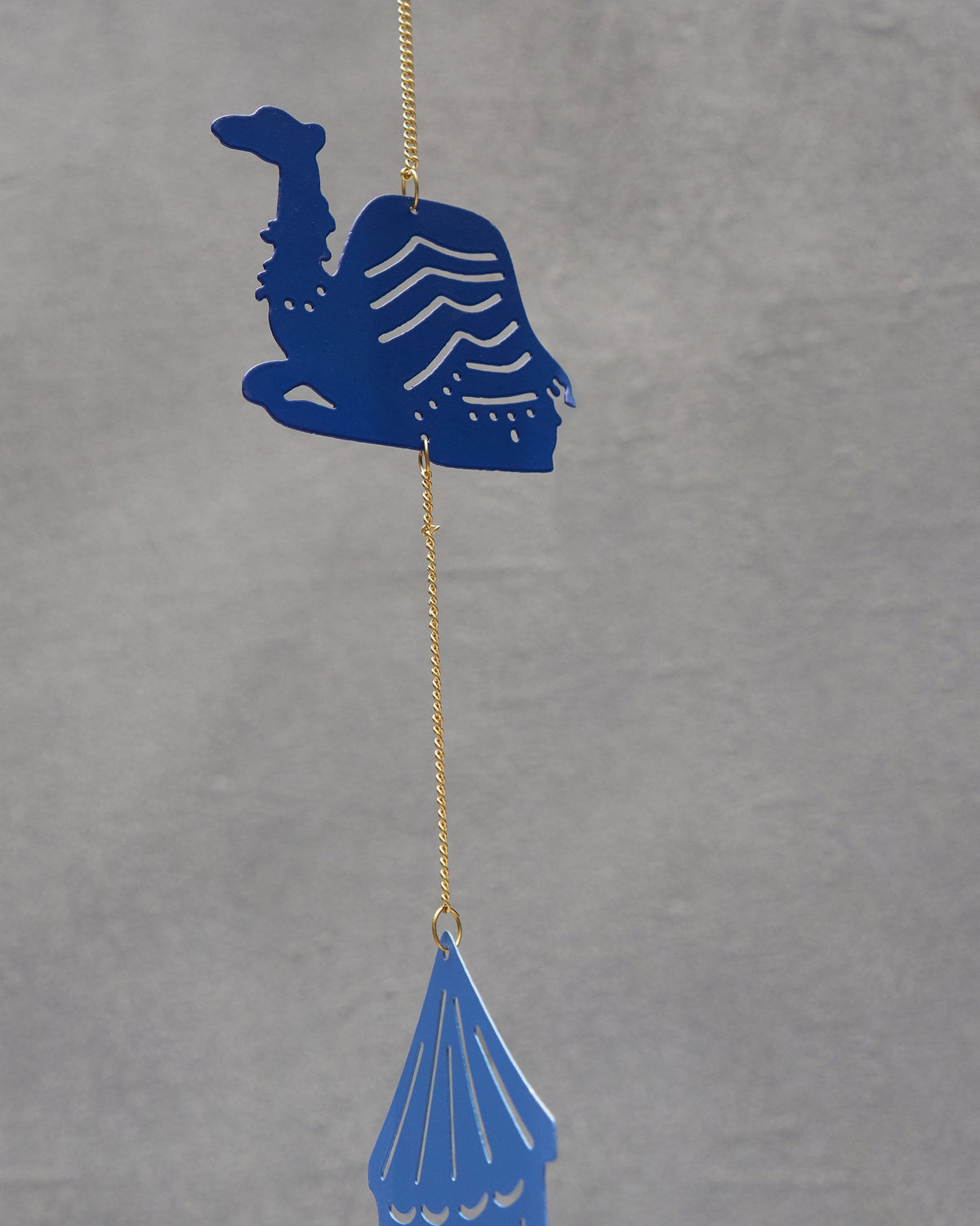 Close-up of the Azraq Toran showing a blue camel motif above a tent.