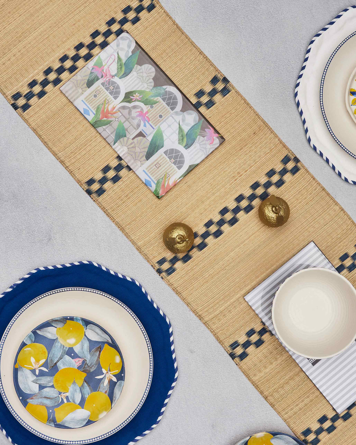 Sahara trivet with a floral print on a woven table runner.