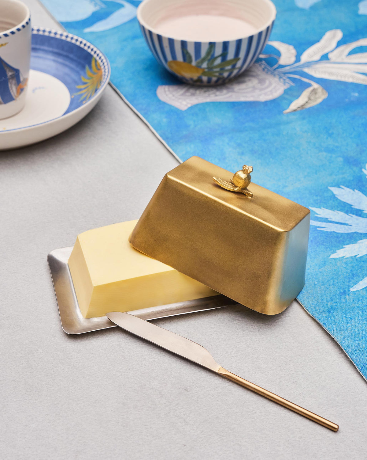 Anar Butter Dish in use, with butter on the tray and the knife alongside.