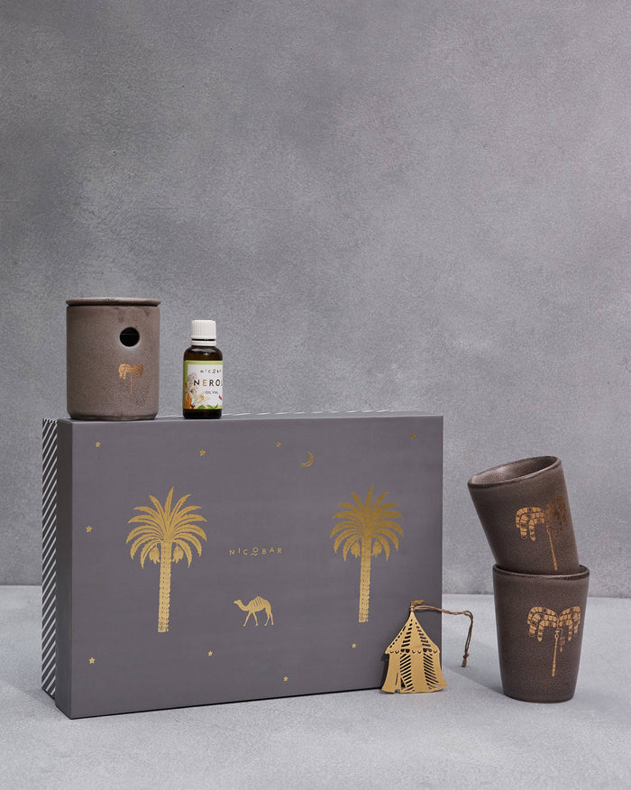 Sahara Gift Set beside its grey gift box, with brown tumblers and a small bottle.